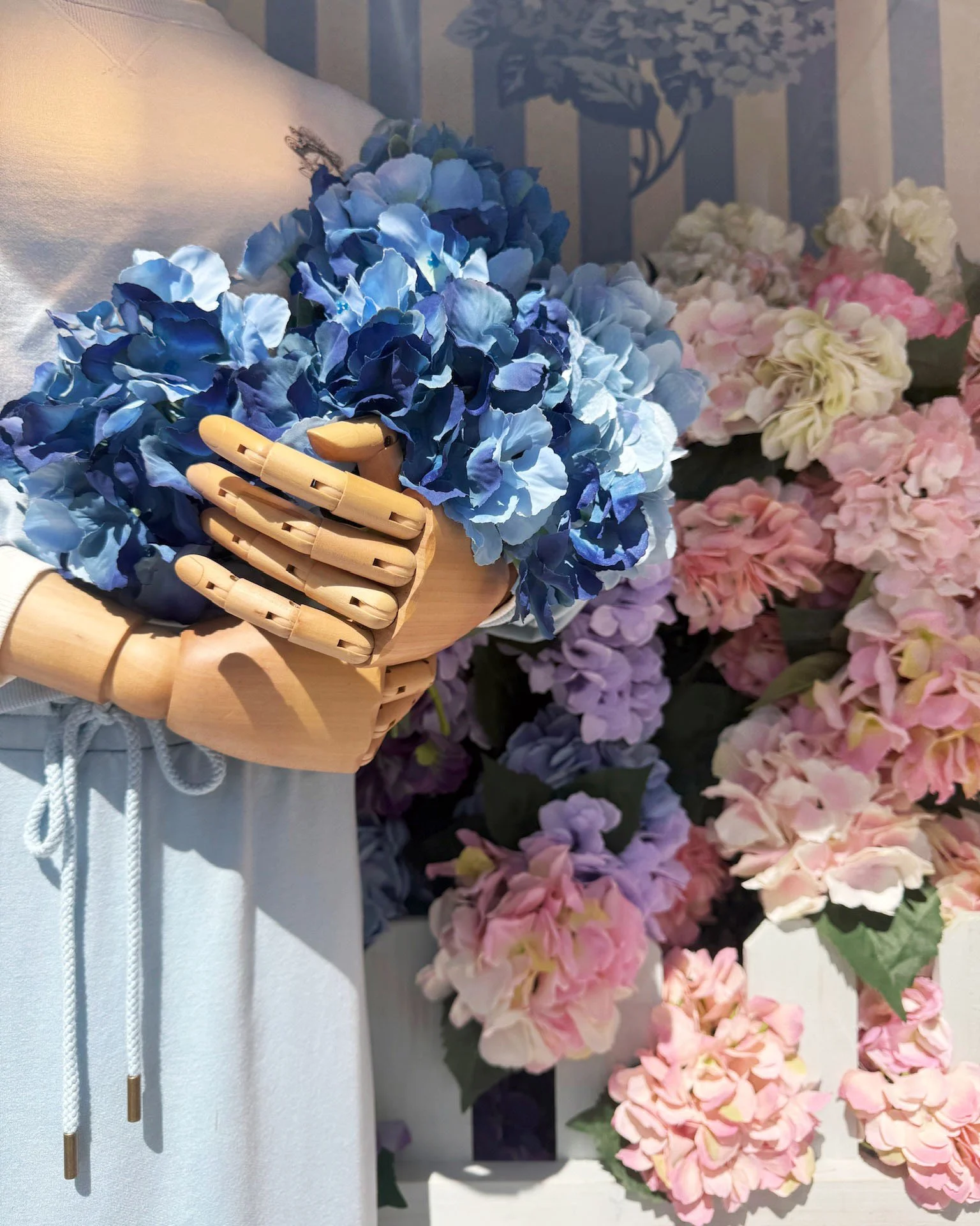 MANNEQUIN STYLING DETAIL OF FLOWERS IN HANDS GALLERY COLLECTION WINDOWS LAKEWOOD NEW JERSEY 