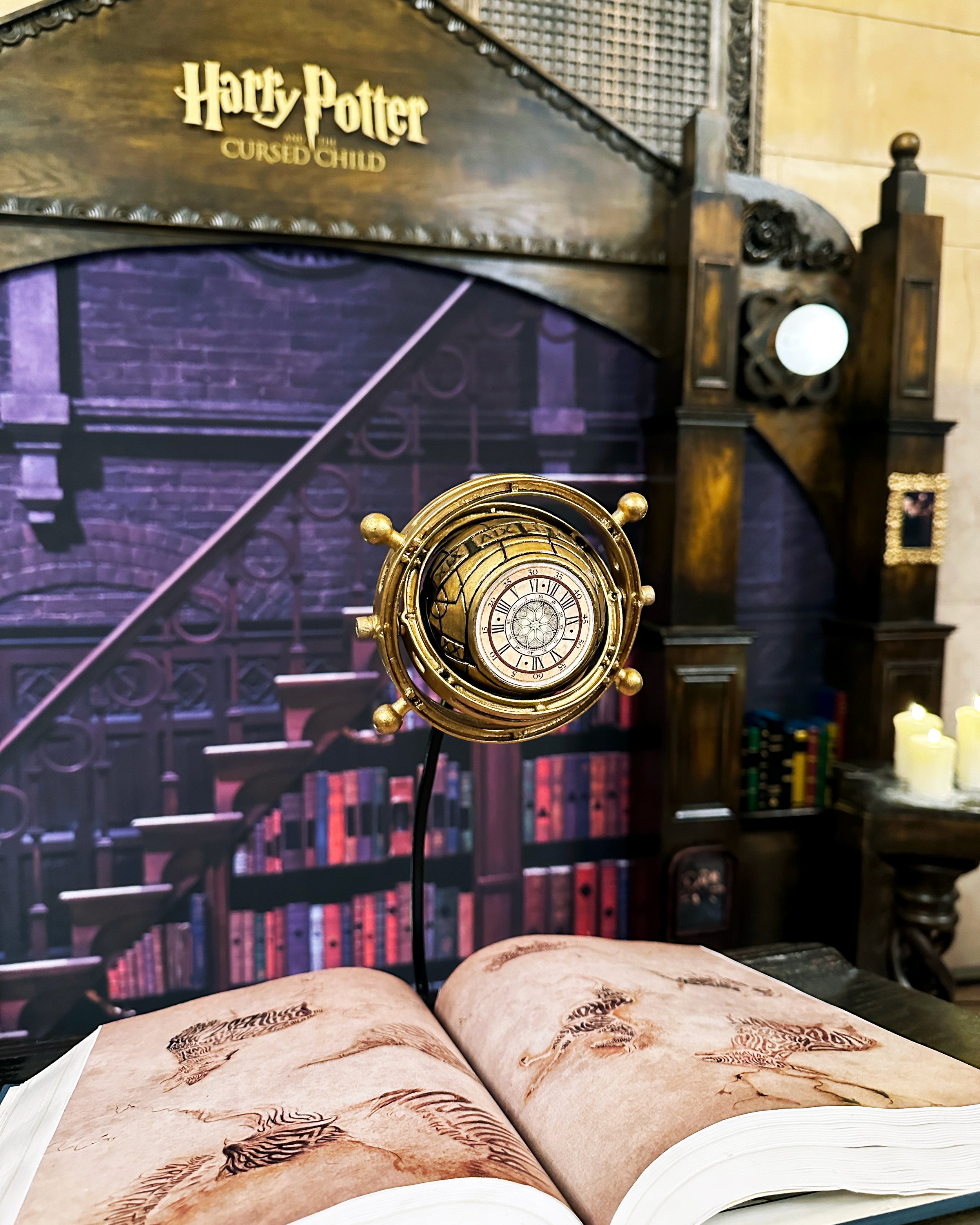Close up of 3D printed time turner and enchantments book for the "Harry Potter and The Cursed Child" photo booth in grand central.
