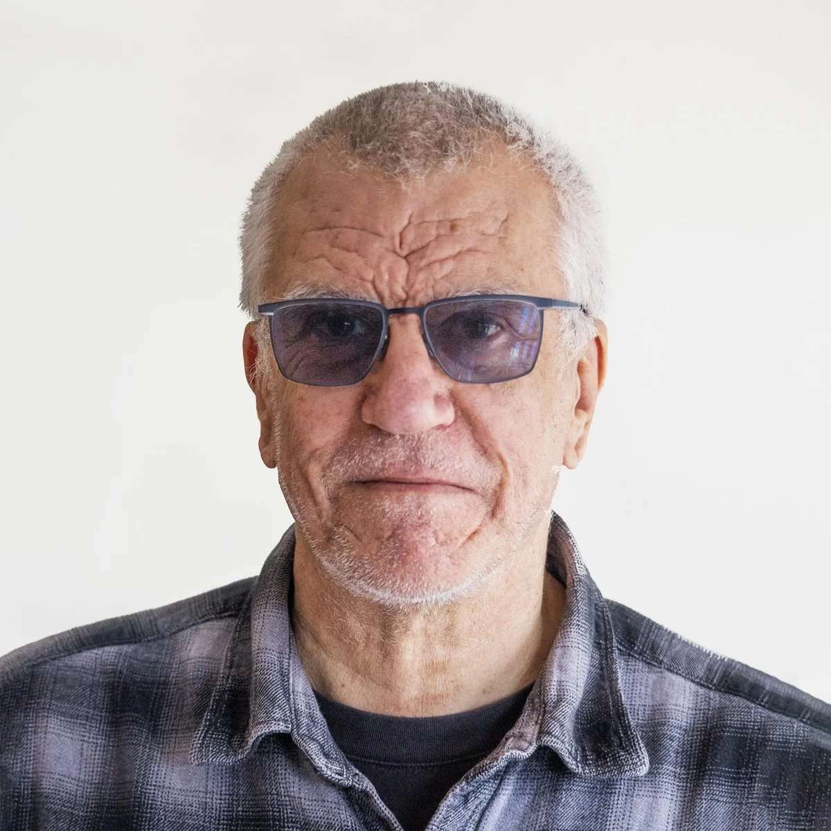 Mike Bailey Facilities, man wearing glasses, short hair and grey shirt