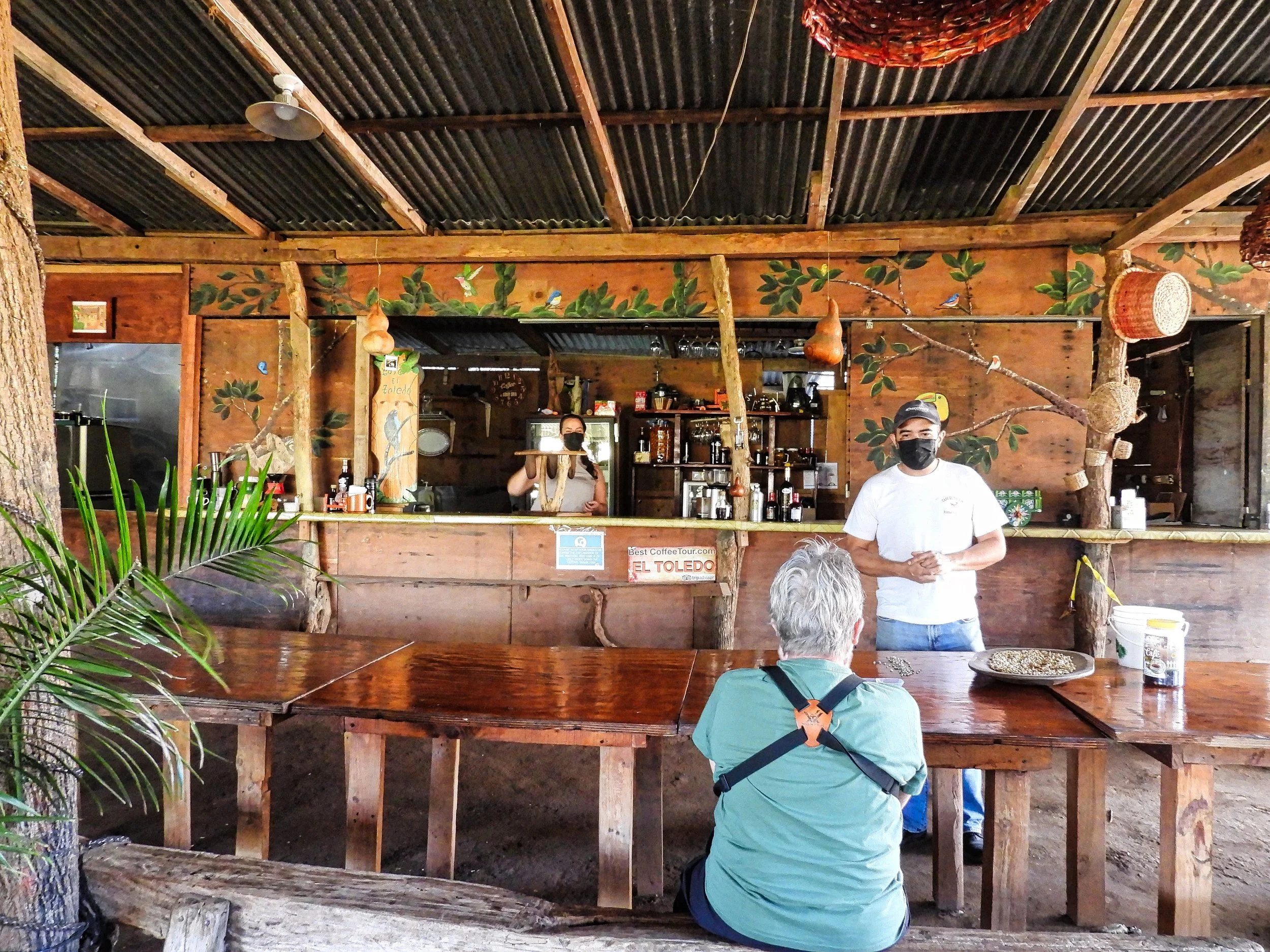 Our tour guide explains the coffee making process, while his wife prepares a coffee tasting for us.