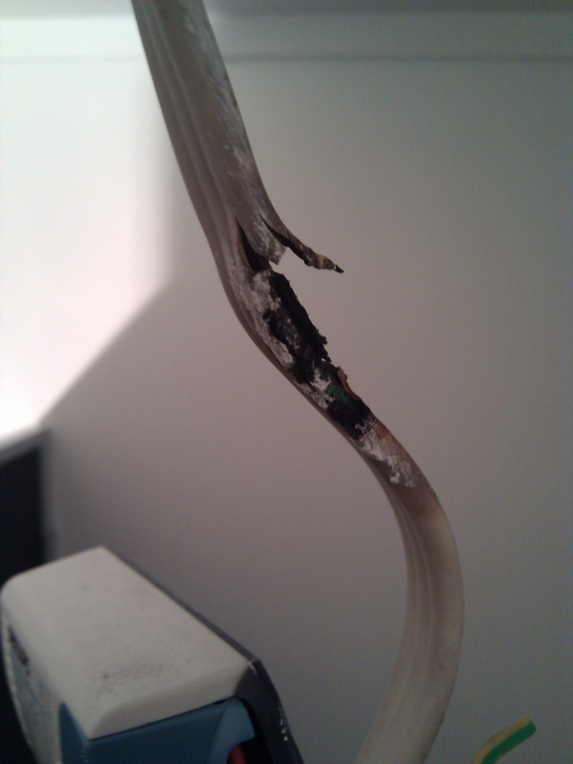 Light cable too close to an old halogen light fitting.