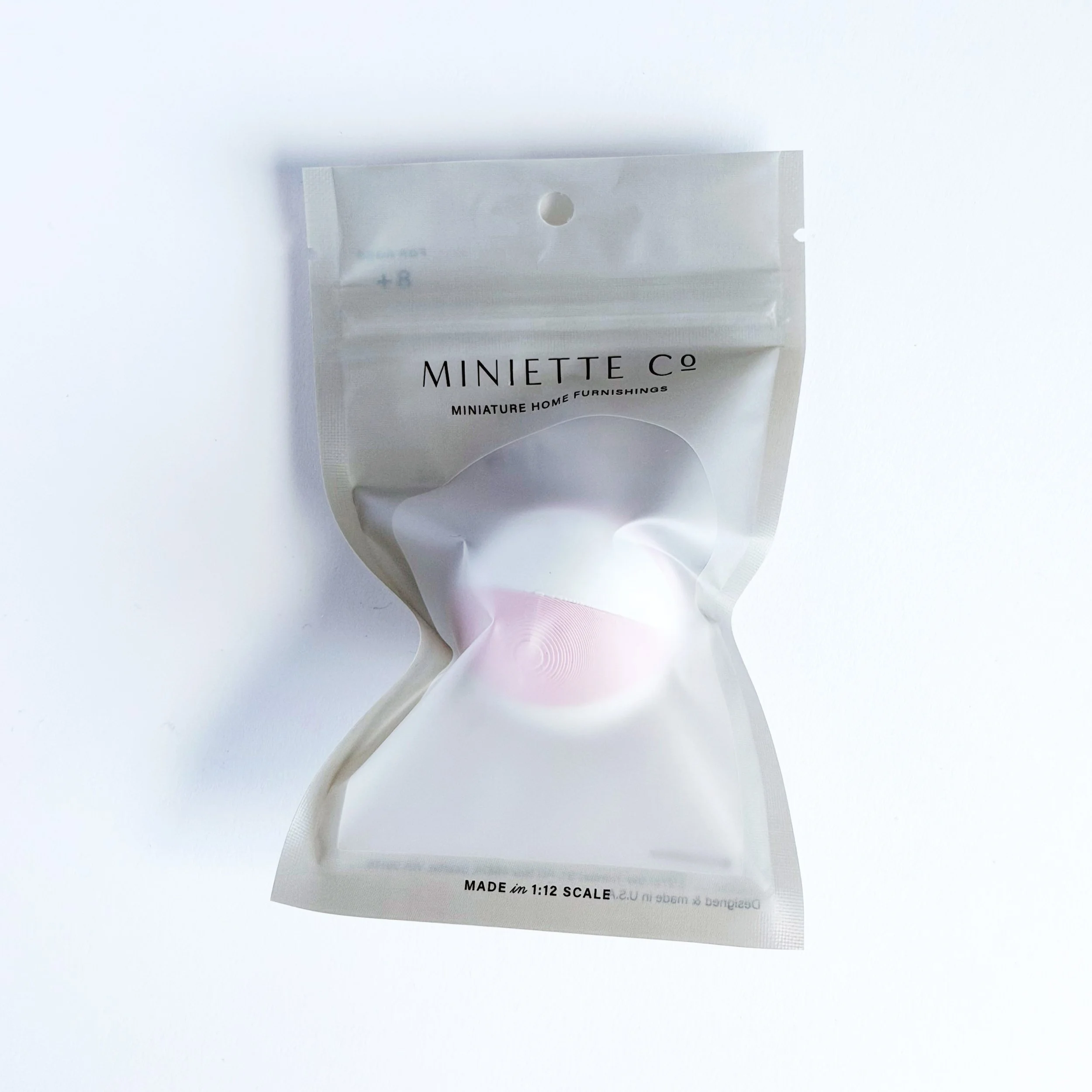 Close-up of pink and white miniature beach ball accessory