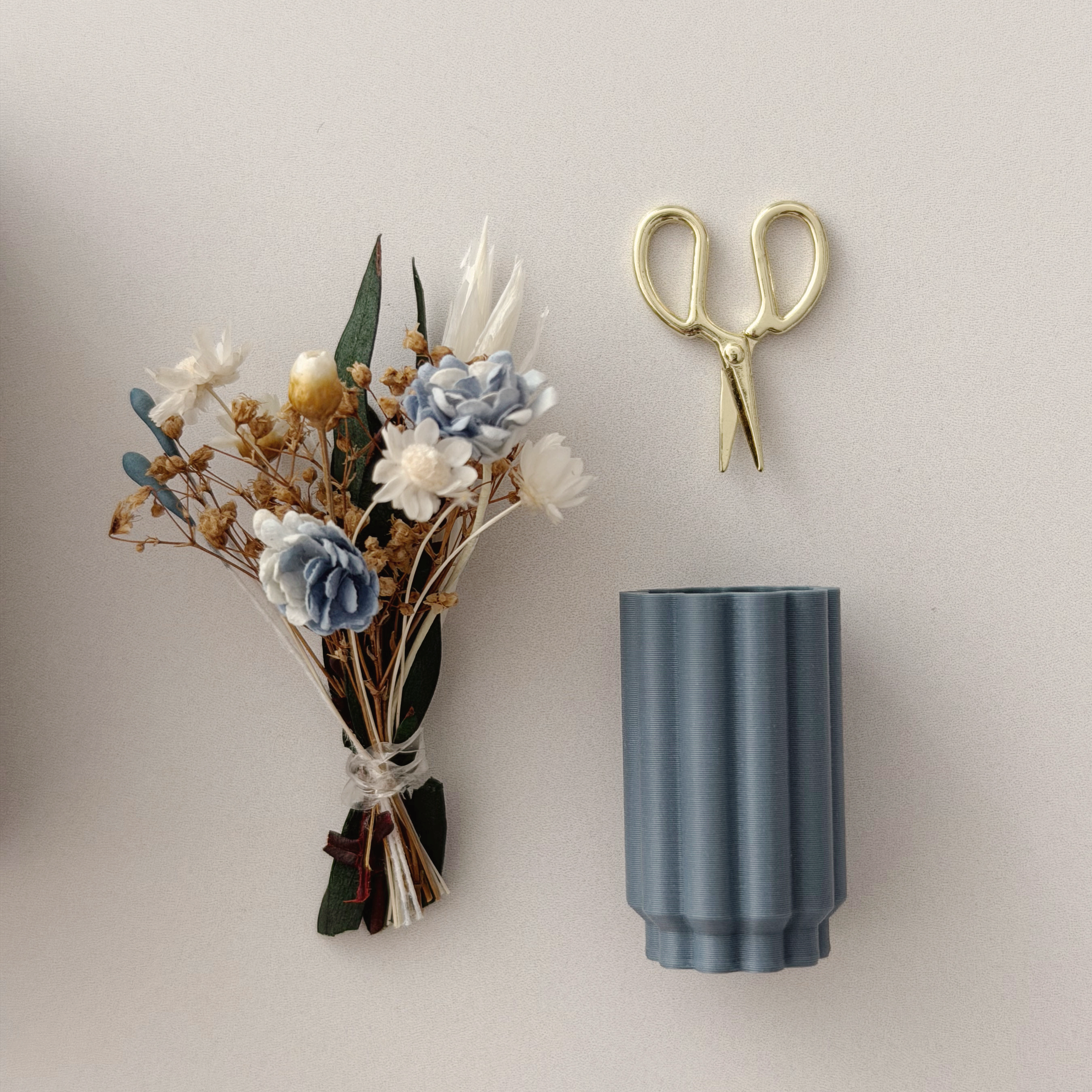 Handcrafted 1:12 scale floral arrangement in a modern ribbed blue vessel