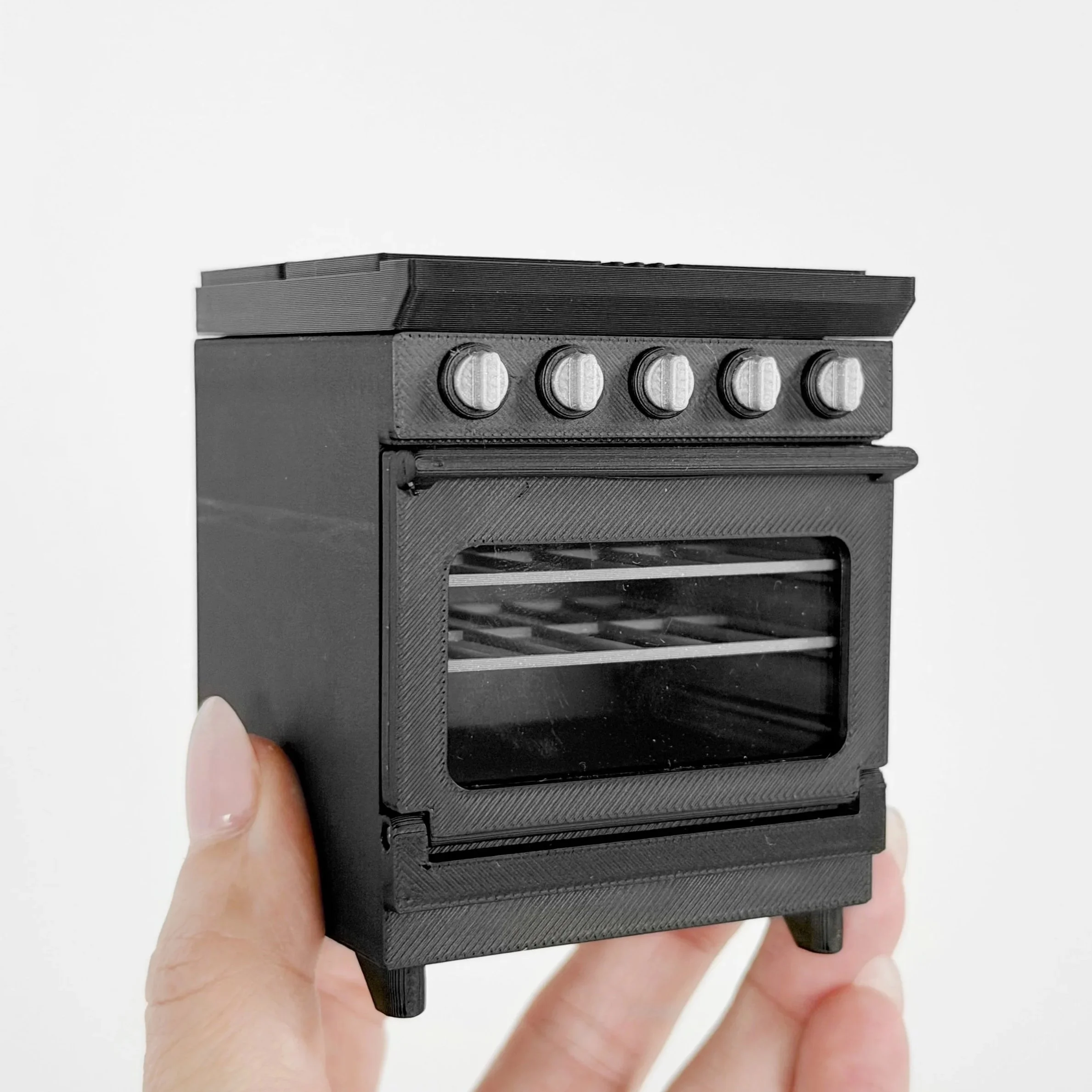 1:12 scale black miniature stove and oven sized to coordinate with dollhouse kitchen cabinets.