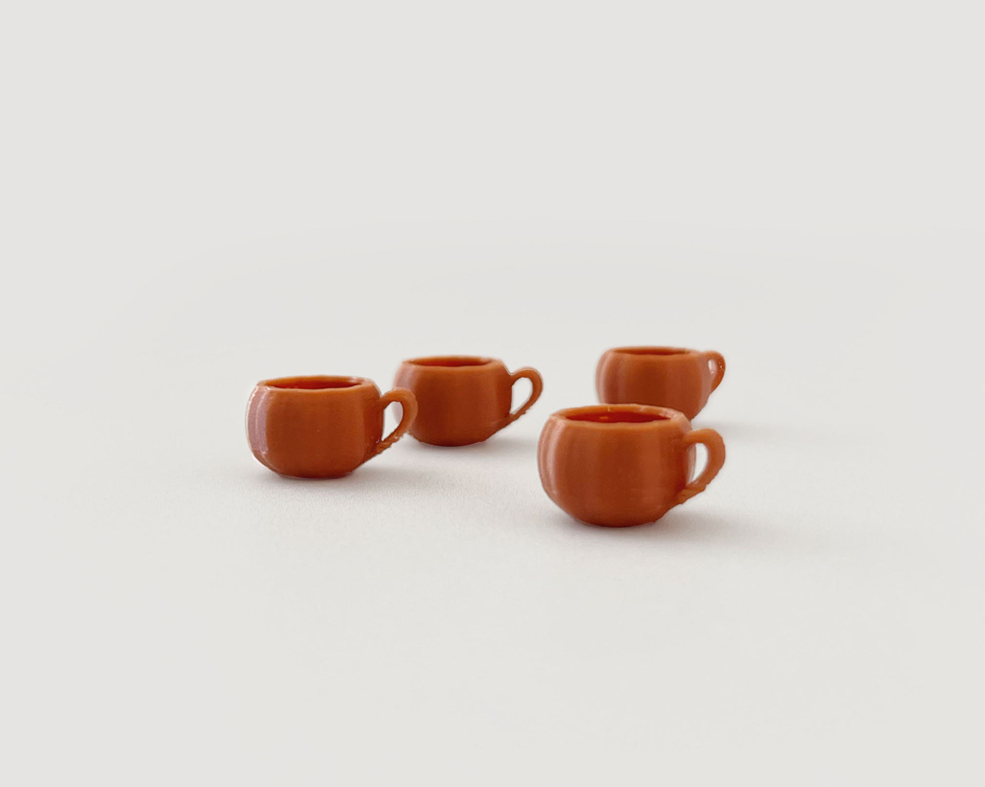 Set of 4 miniature pumpkin mugs – 1:12 scale plastic dollhouse coffee cups for fall décor and kitchen accessories.