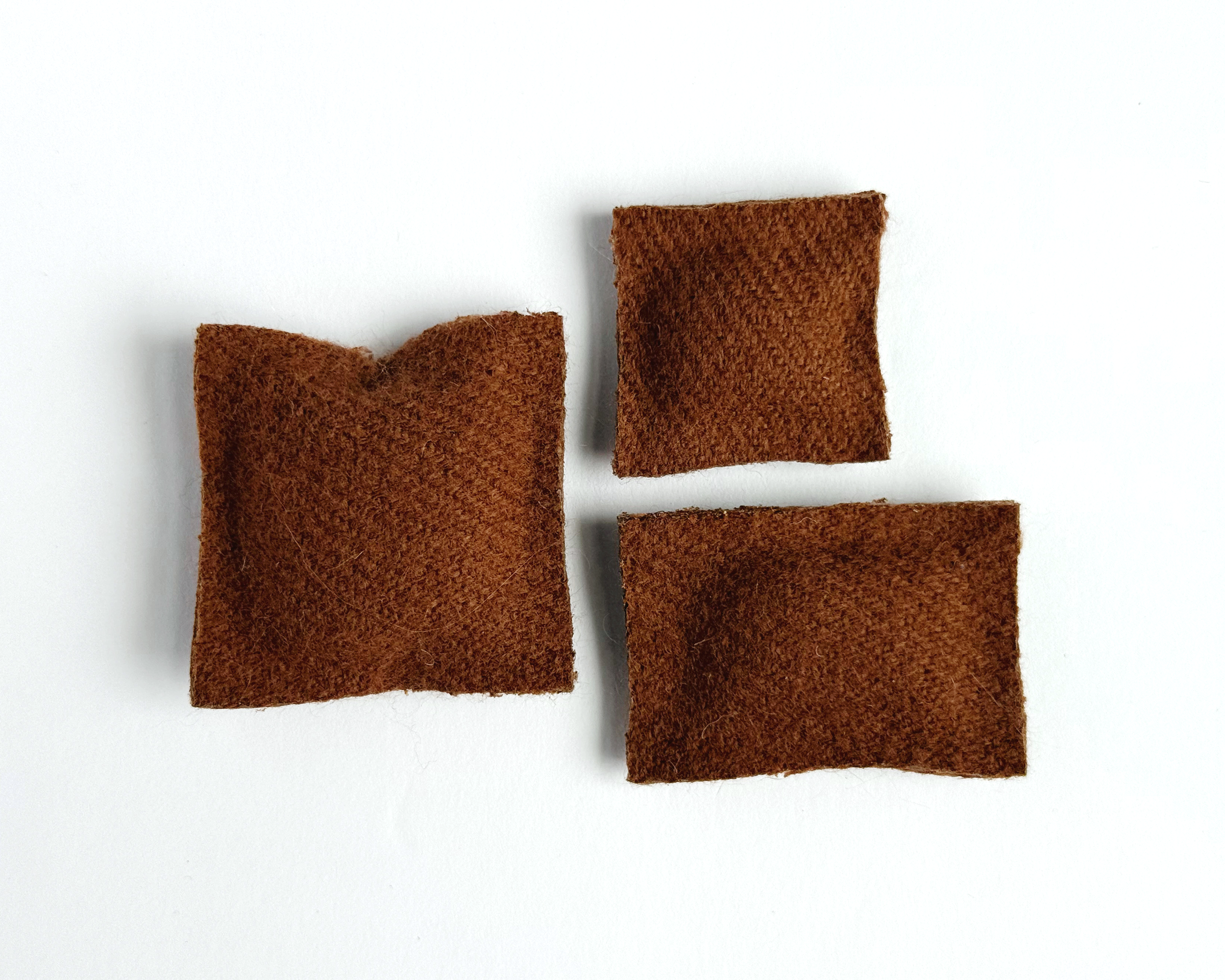 Set of 3 cozy miniature dollhouse throw pillows in 1:12 scale. Handmade solid woven acrylic pillows in terra cotta.