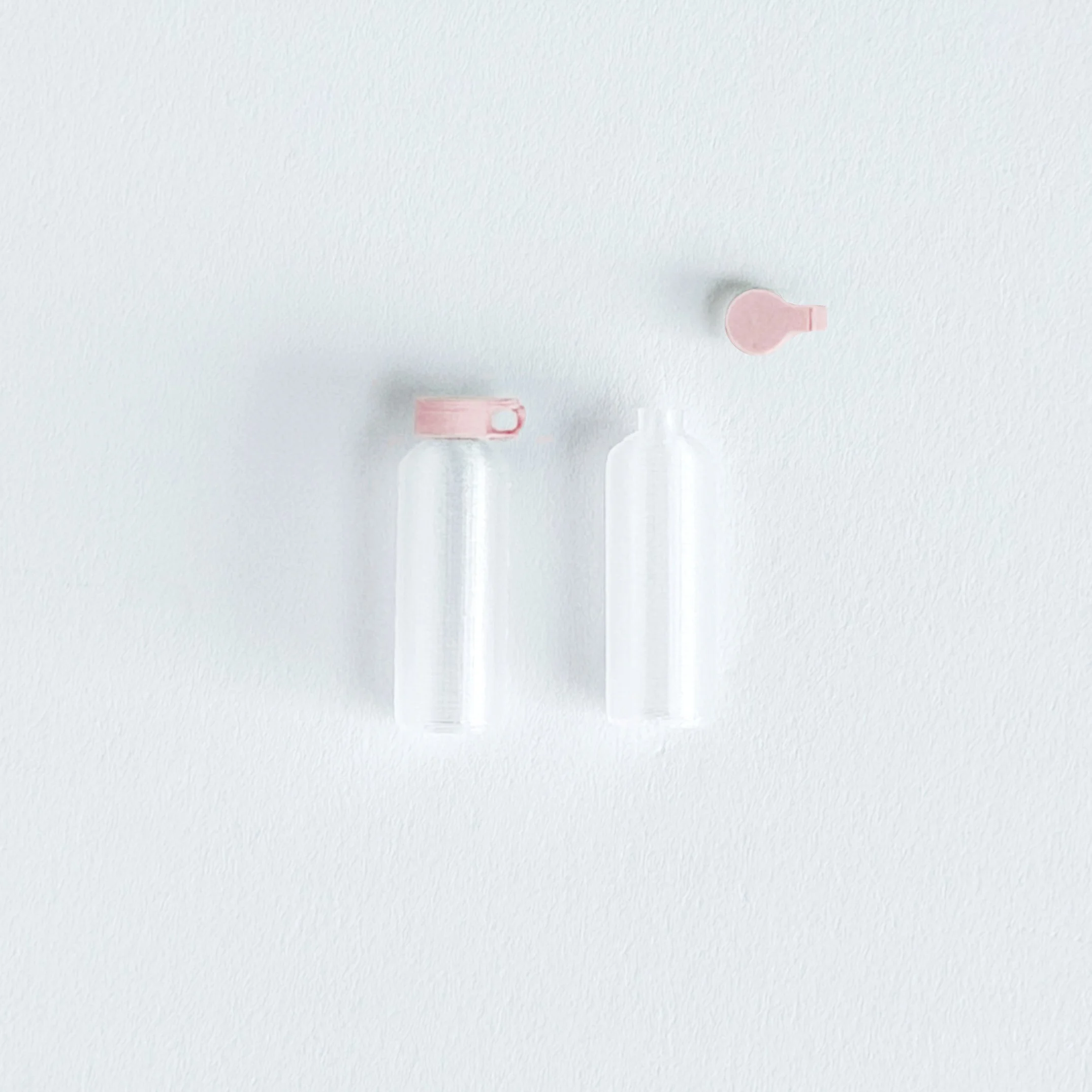 1:12 scale miniature pink water bottle on bright white background