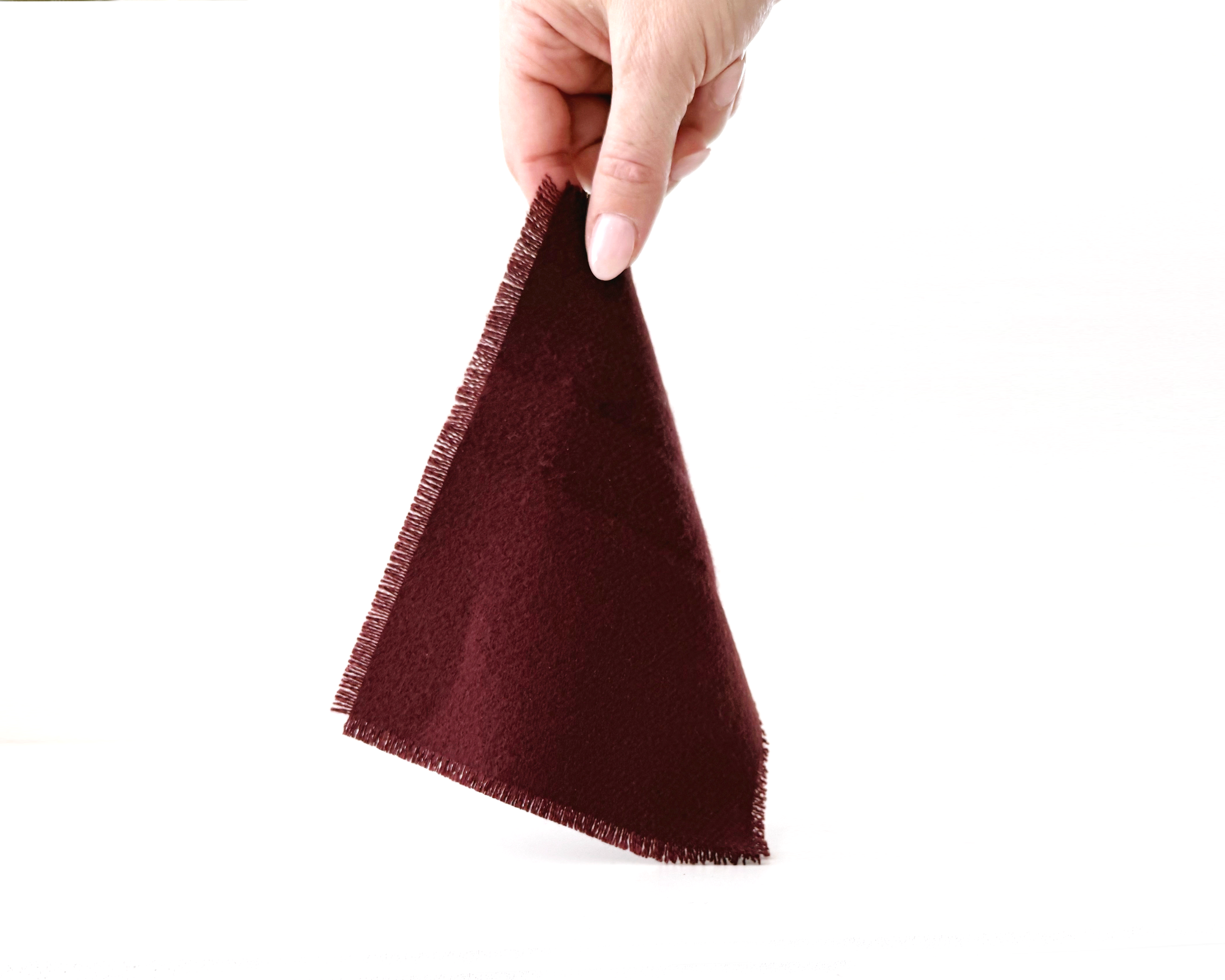 Handmade dollhouse blanket in 1:12 scale. Soft woven acrylic throw with fringed edge, available in currant