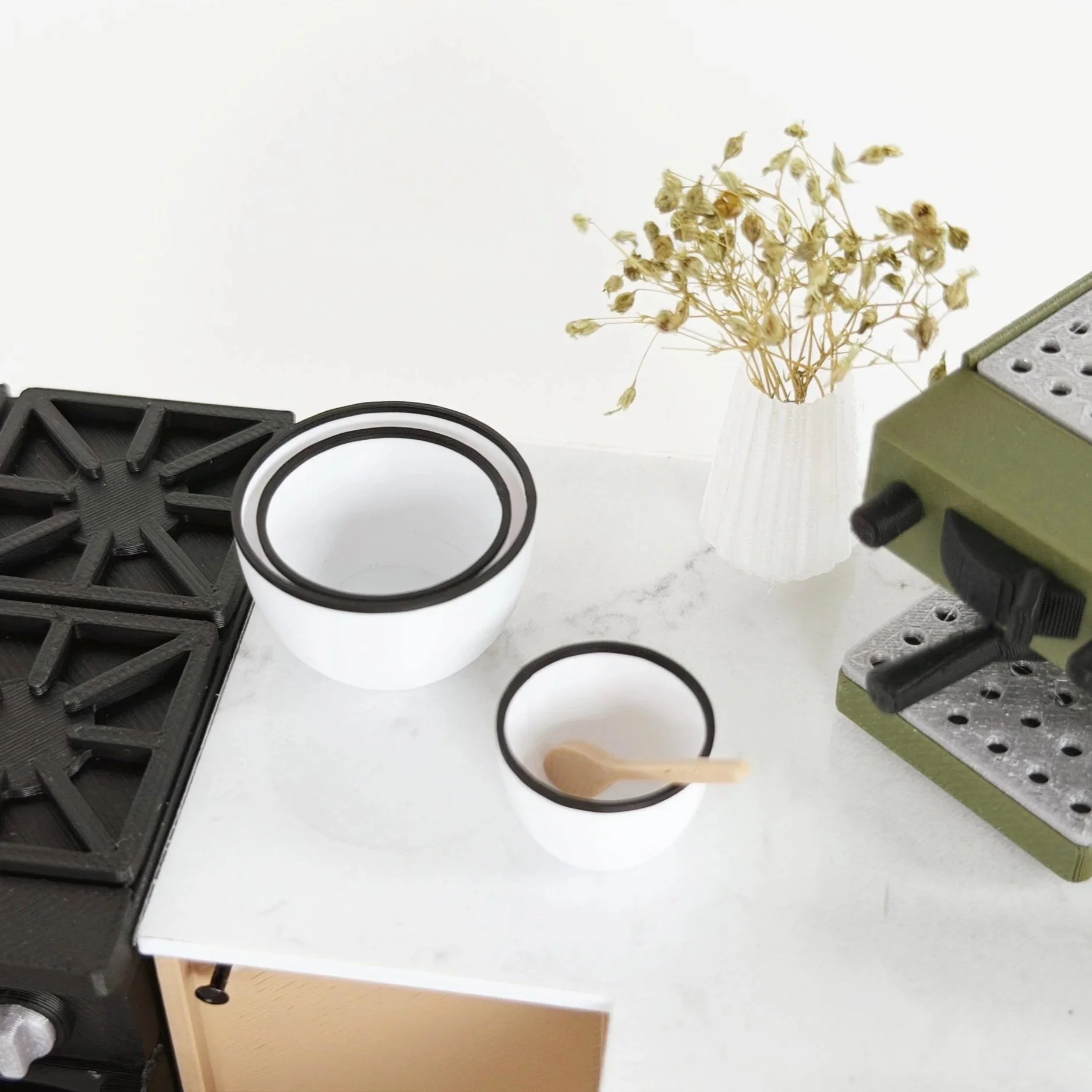 Set of three white 1:12 scale miniature nesting bowls with black trim, stacked together for display.