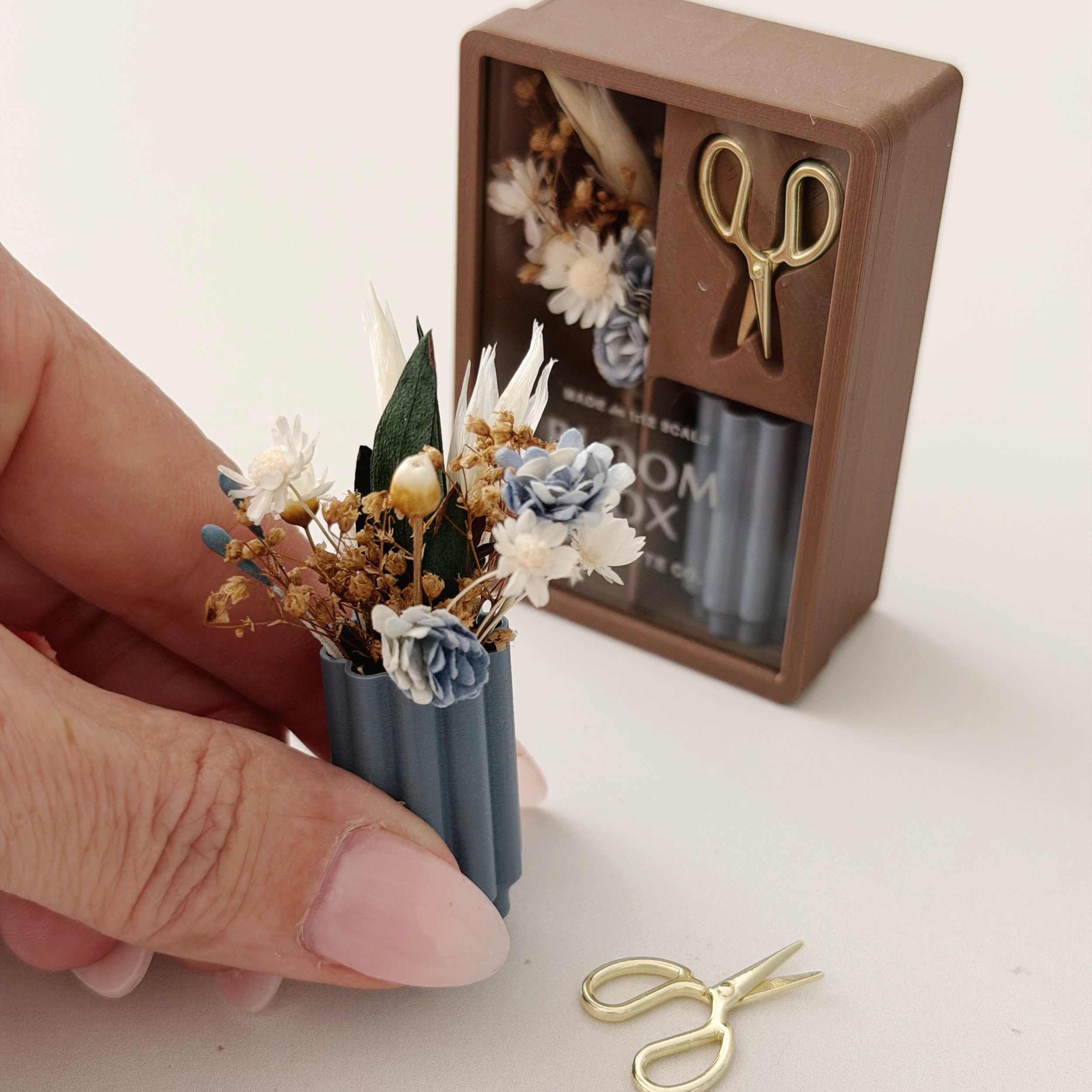 Blue and cream miniature flower arrangement styled as tiny home decor