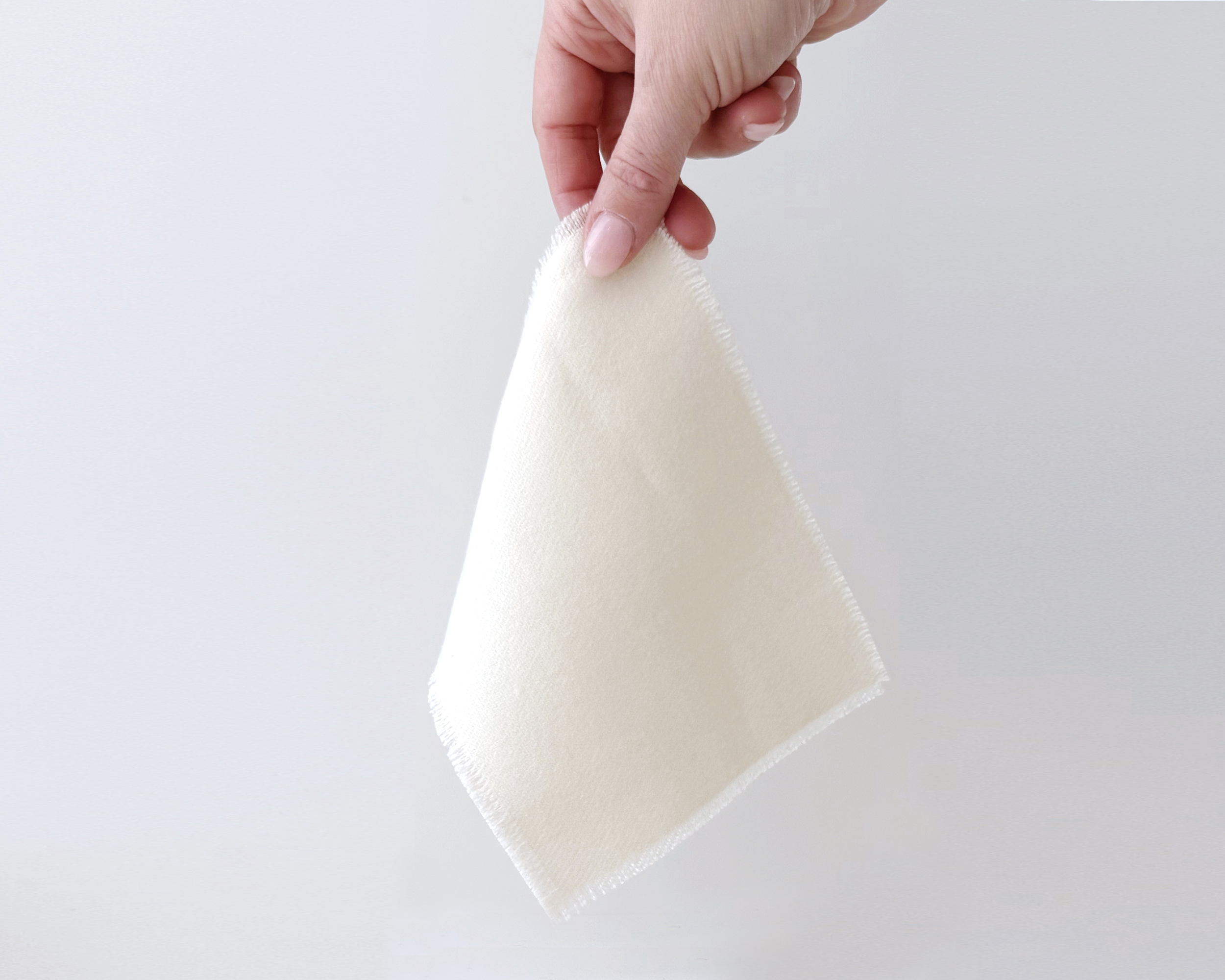 Miniature dollhouse accessory – solid woven throw blanket with fringe. 1:12 scale handcrafted design in soft ivory fabric.