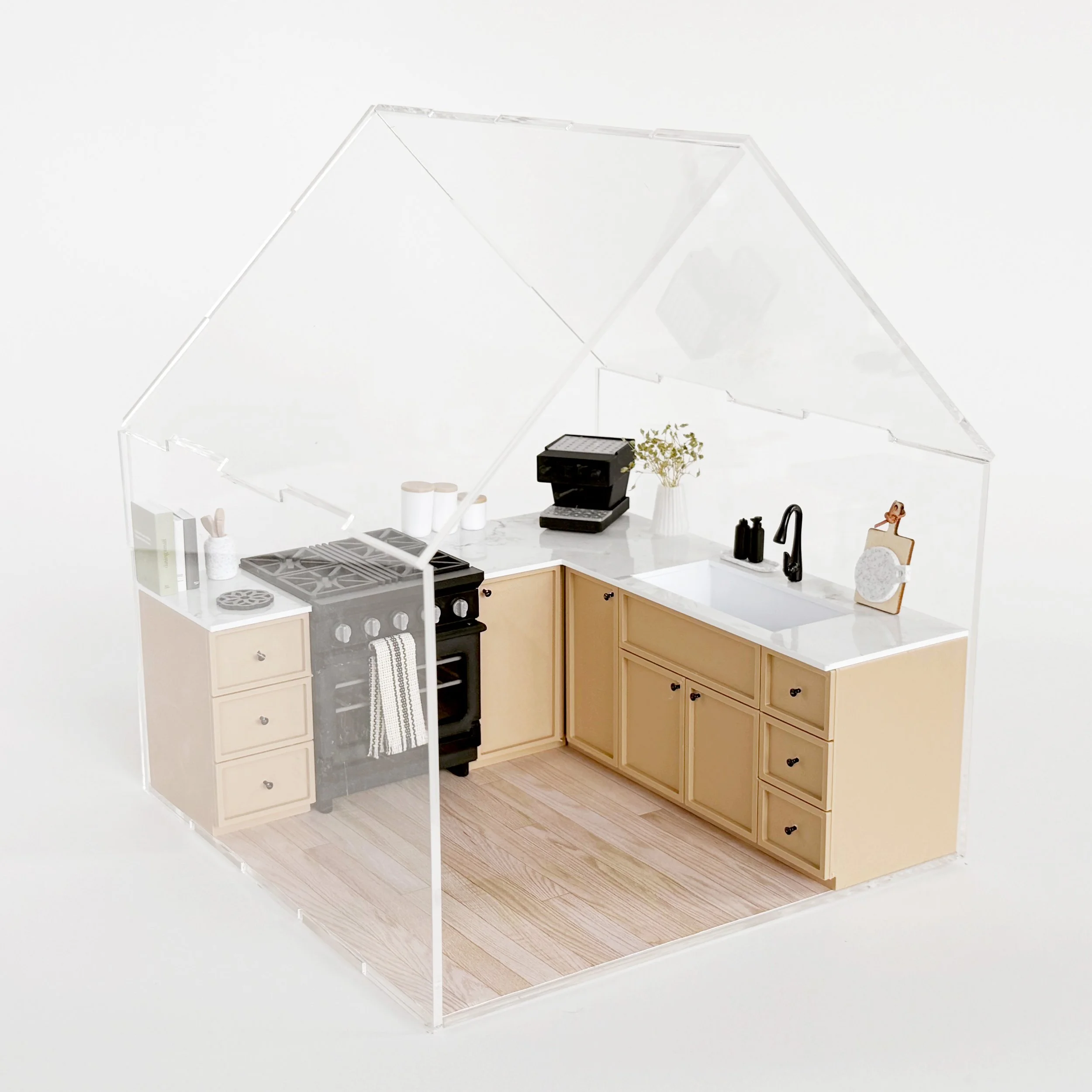 Modern miniature kitchen setup featuring natural cabinets and oven, styled inside a clear acrylic dollhouse display. (Copy)