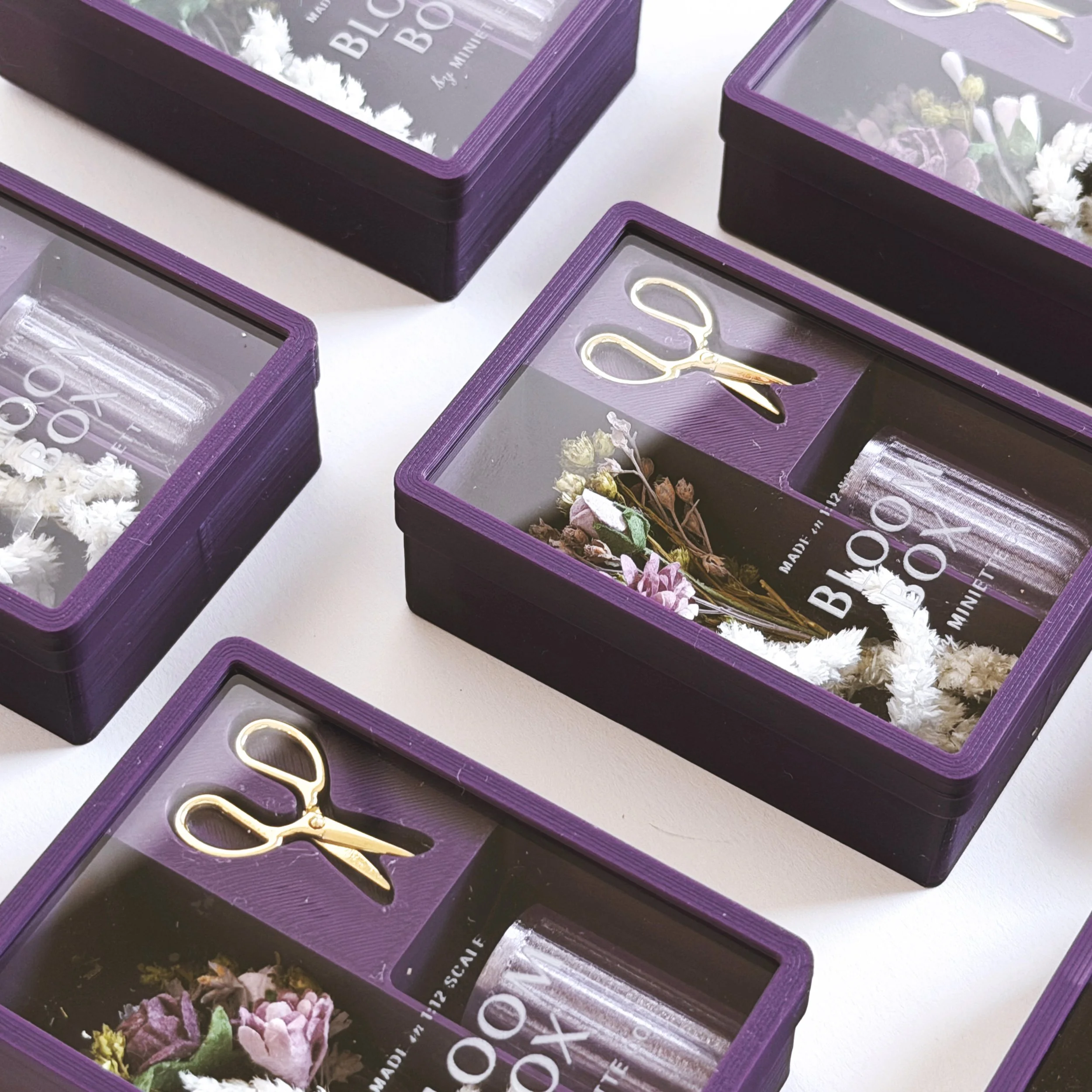 Purple floral Bloom Box miniature gift set styled in clear box with preserved flowers, vase, and scissors