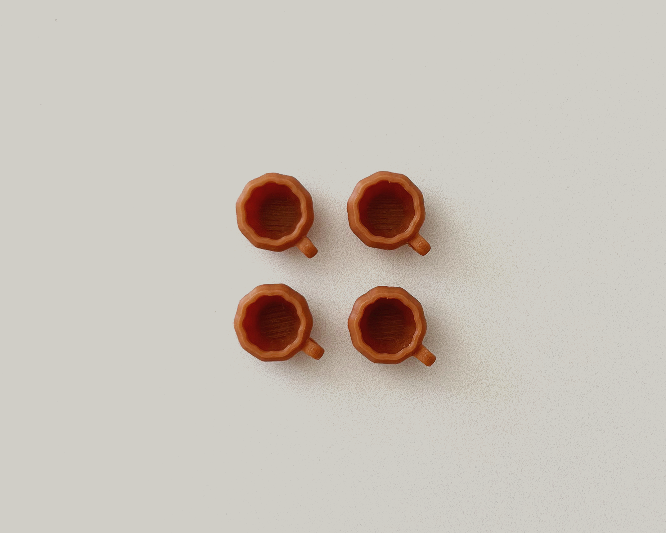 Set of 4 miniature pumpkin mugs – 1:12 scale plastic dollhouse coffee cups for fall décor and kitchen accessories.