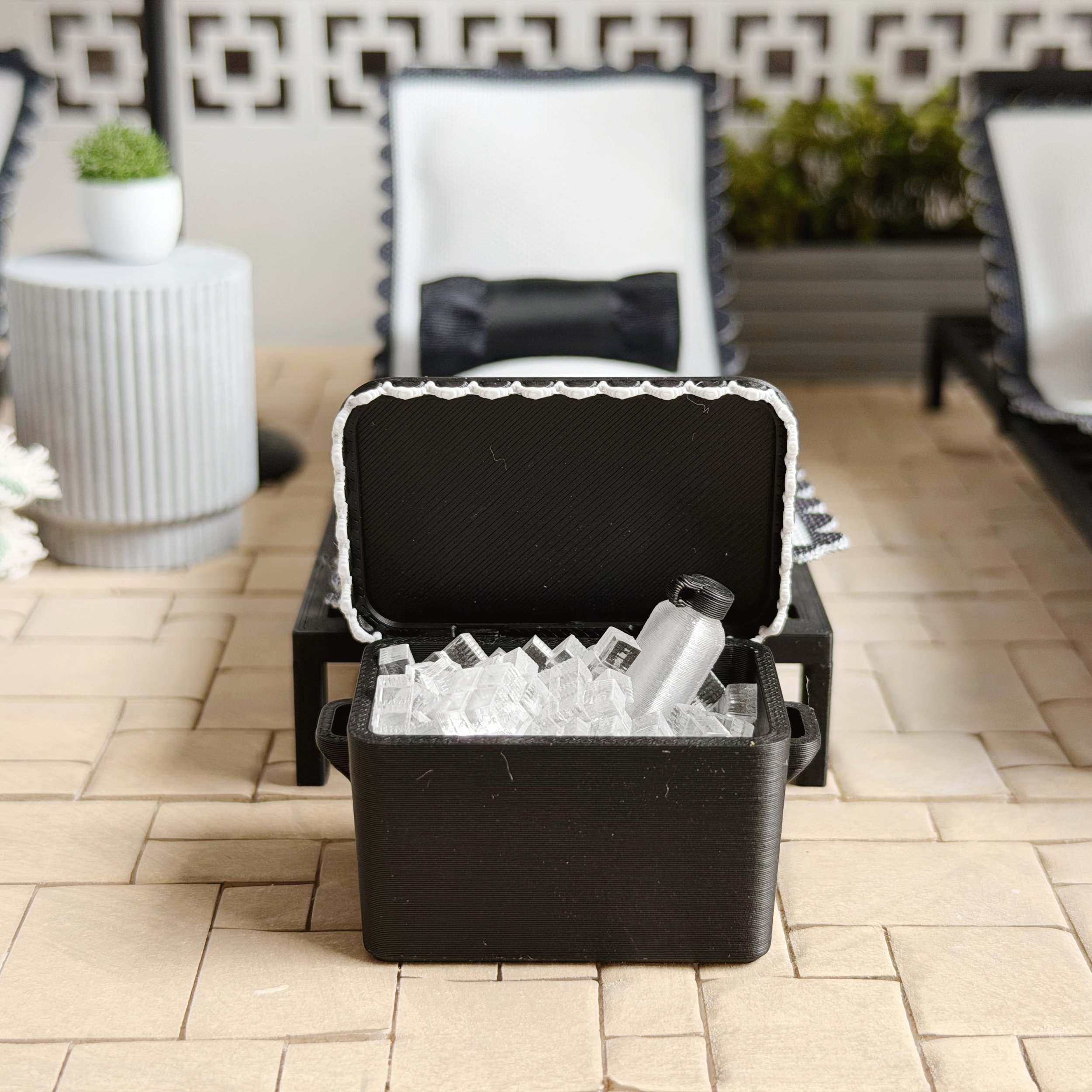 Modern dollhouse pool and patio scene styled with black and white outdoor furniture (Copy)