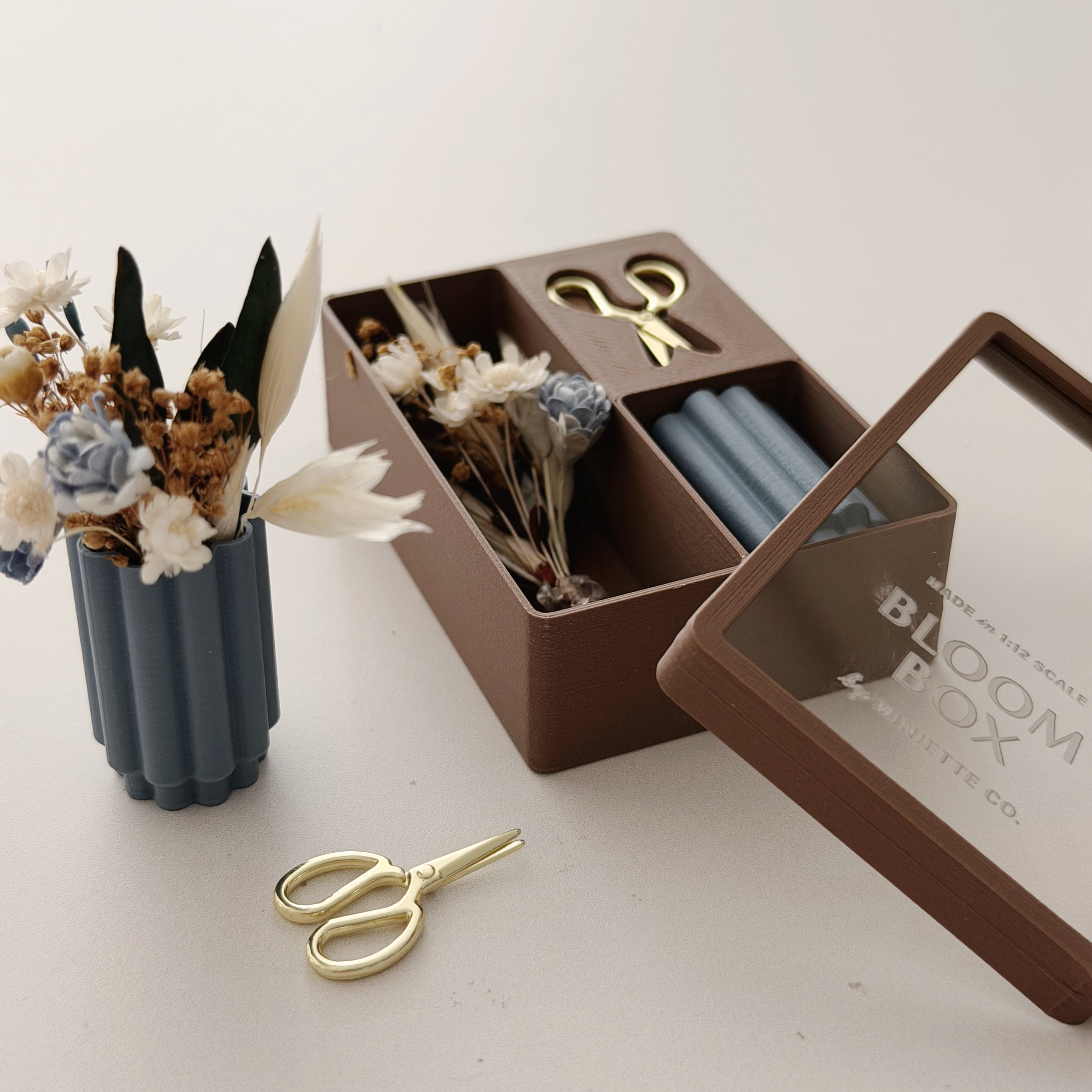 Blue miniature Bloom Box with cream flowers and warm natural dried stems