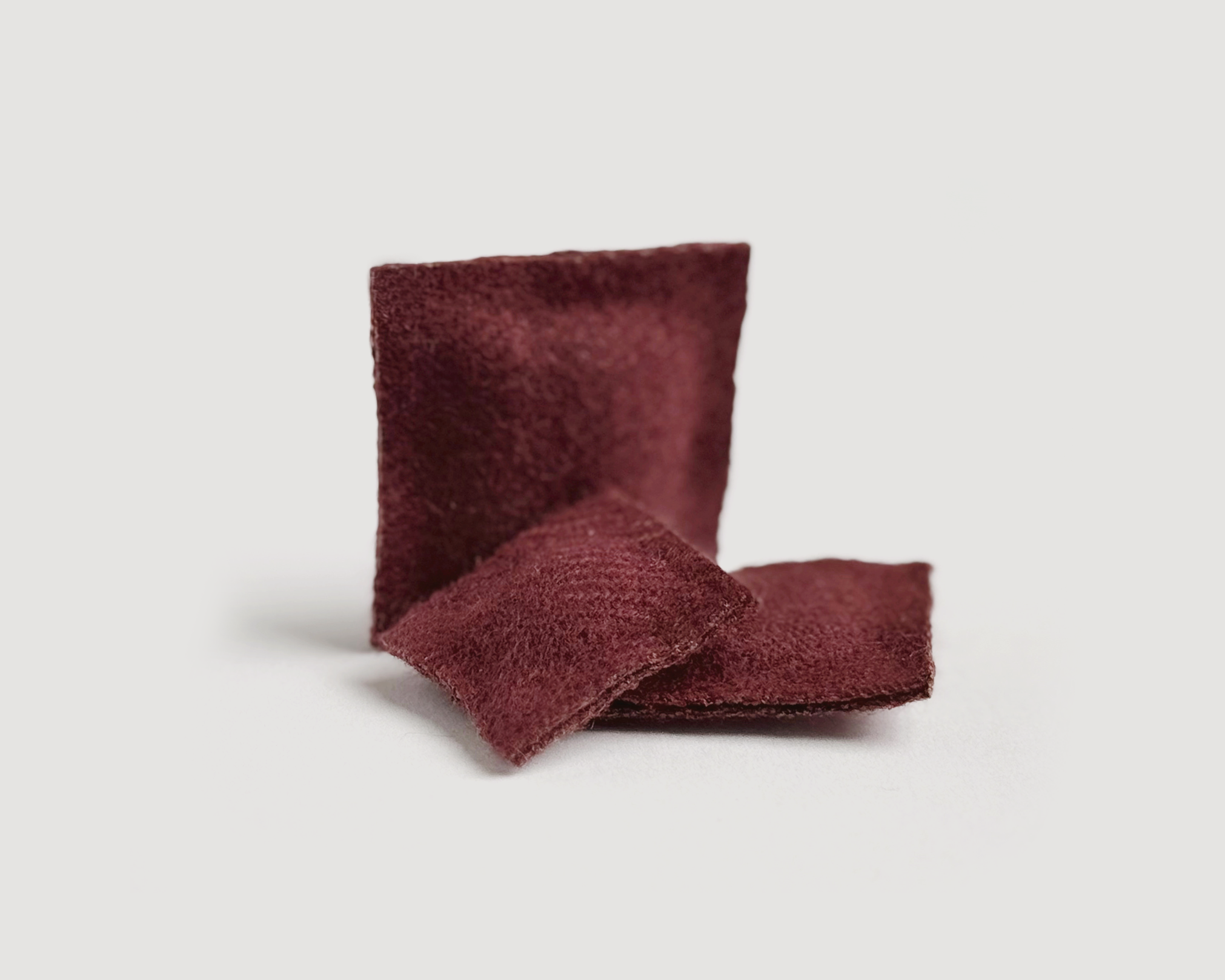 Set of 3 miniature dollhouse throw pillows in 1:12 scale. Handmade solid woven acrylic pillows in currant.