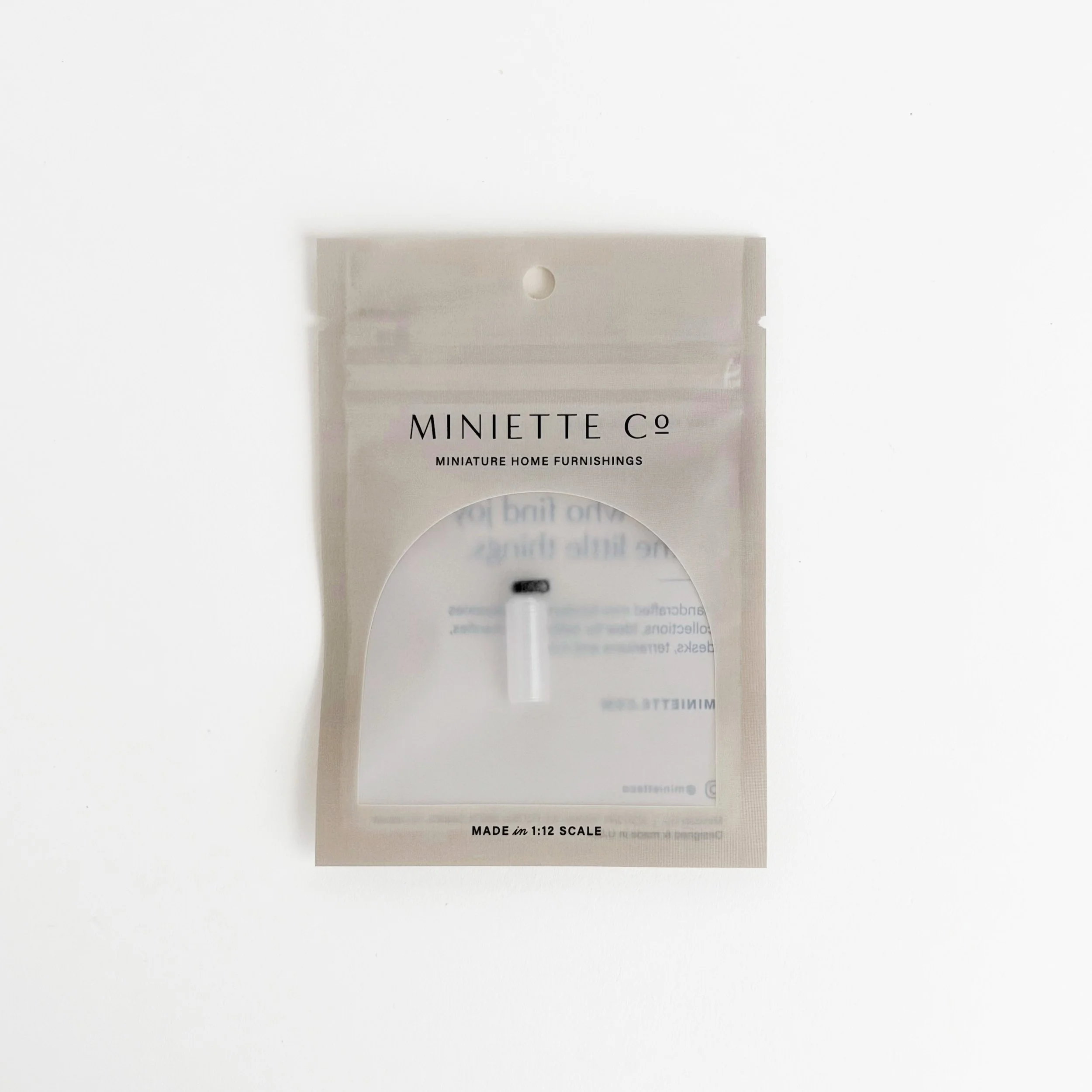 1:12 scale miniature black water bottle on bright white background