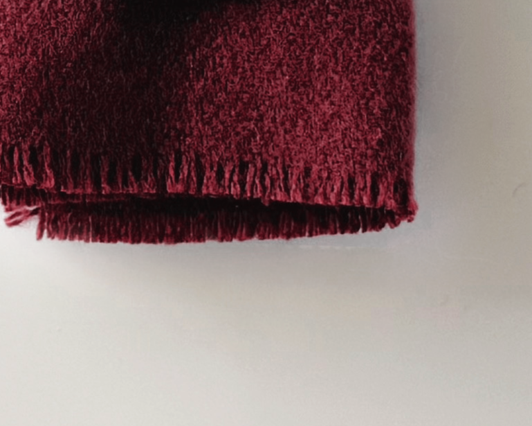 Handmade dollhouse blanket in 1:12 scale. Soft woven acrylic throw with fringed edge, available in currant