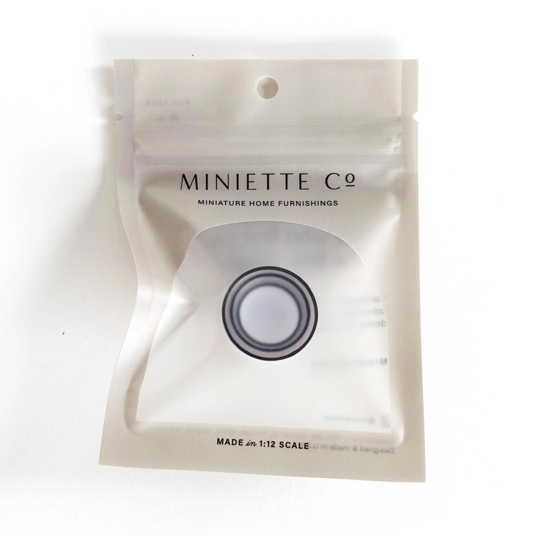 Set of three white 1:12 scale miniature nesting bowls with black trim, stacked together for display.