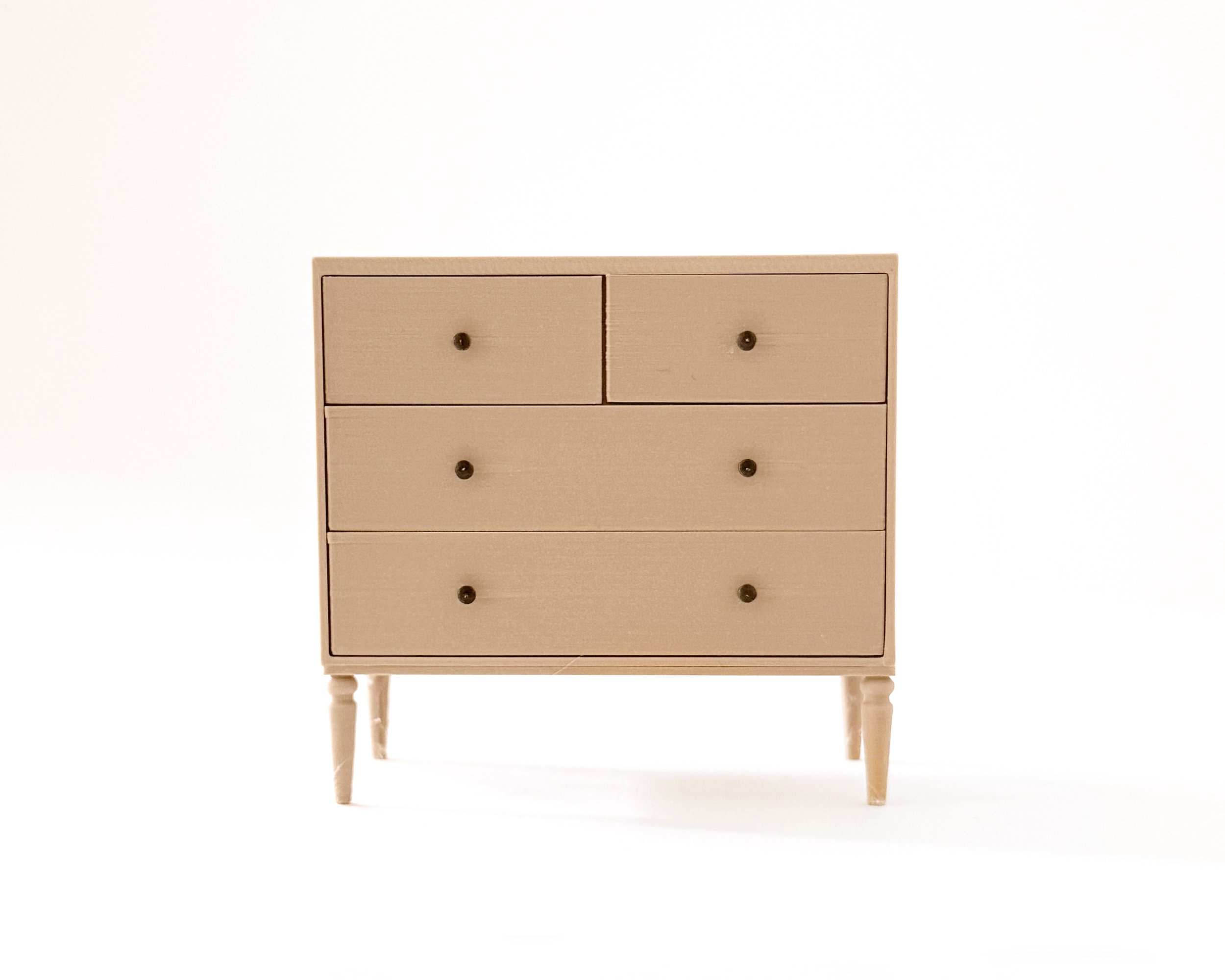 Miniature dollhouse dresser with 4 drawers in natural wood color. Elegant, modern storage featuring intricate tapered legs. Functioning drawers.