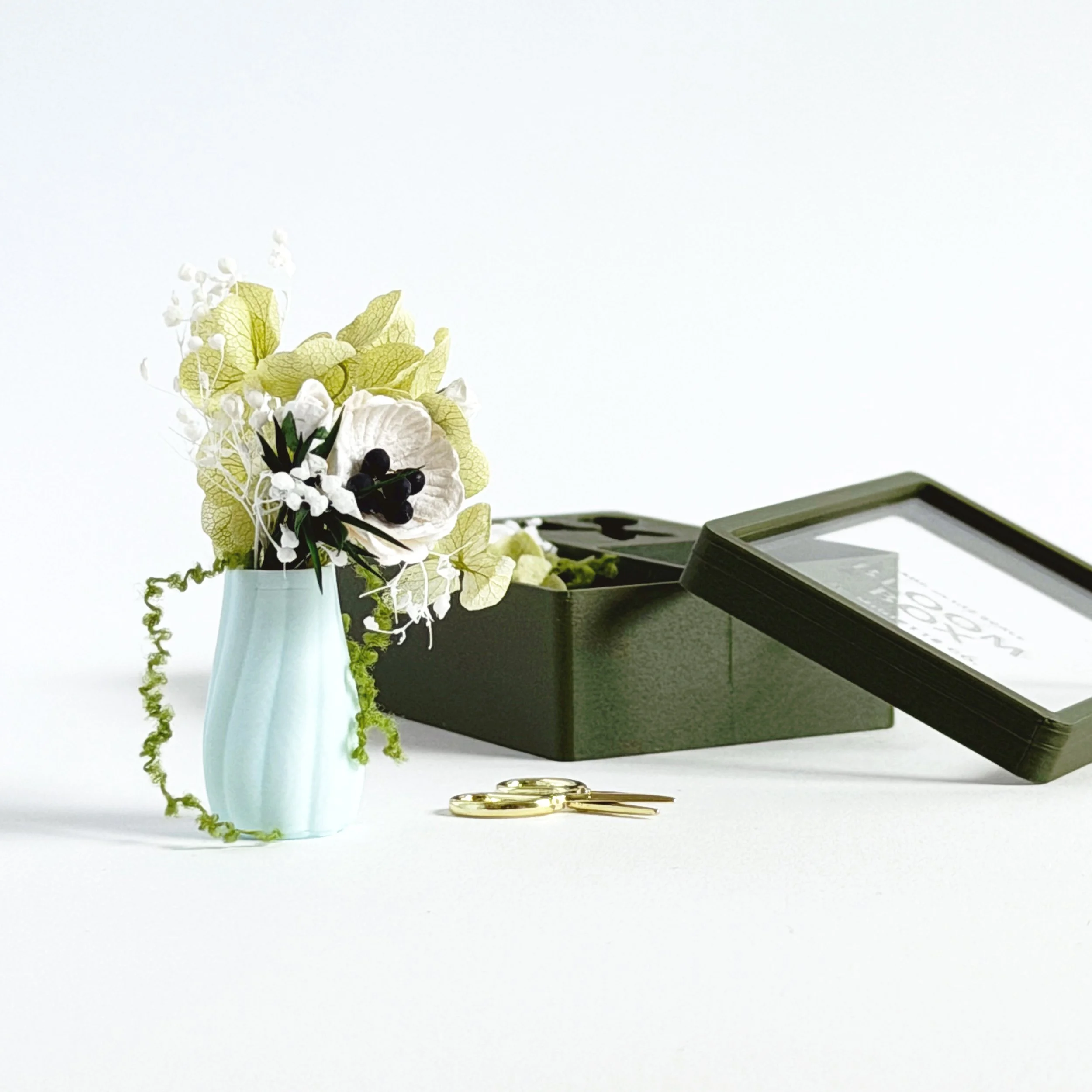 Miniature green floral arrangement removed from box with vase and tiny scissors, dollhouse scale decor