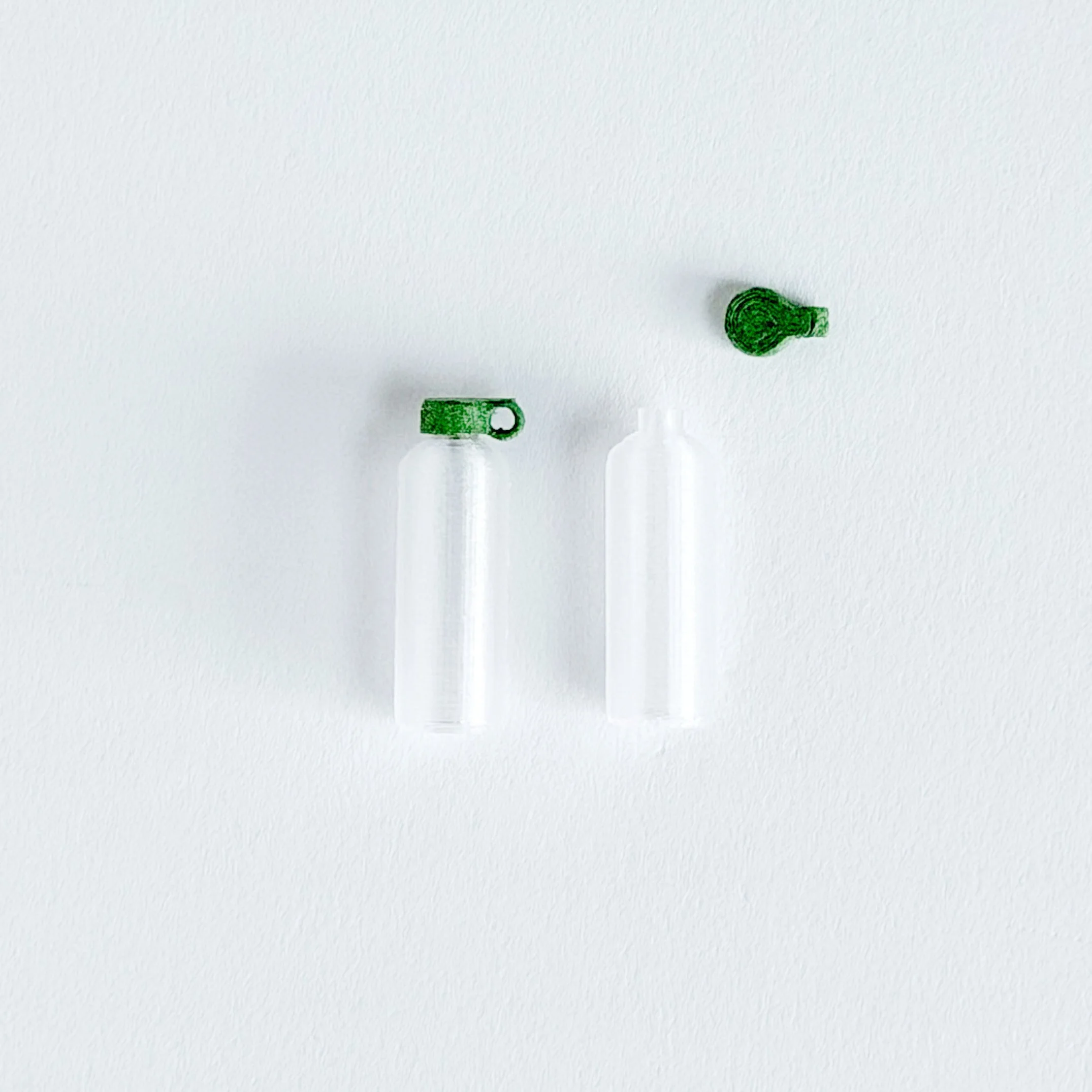 1:12 scale miniature green water bottle on bright white background