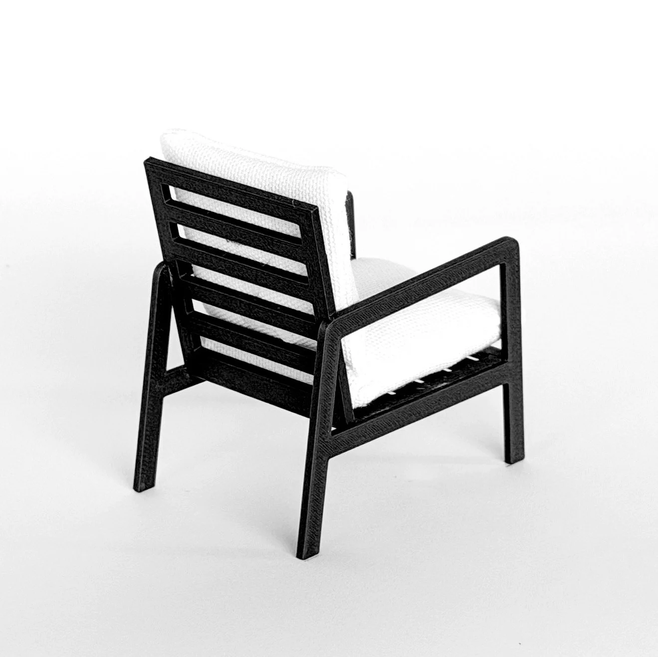 Close-up detail of miniature armchair showing smooth finish and structured design, 1:12 scale dollhouse furniture