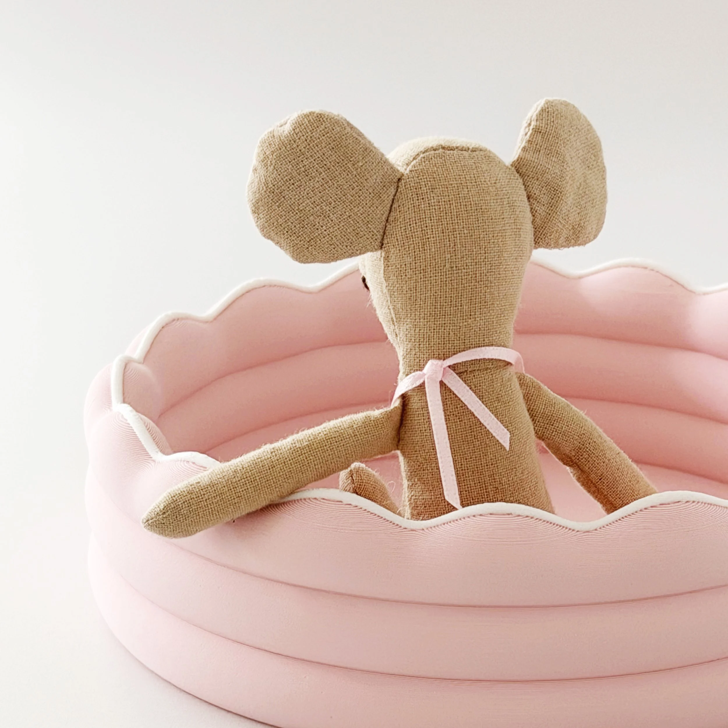 Close-up of the miniature kiddie pool showing its smooth finish and scalloped edge.