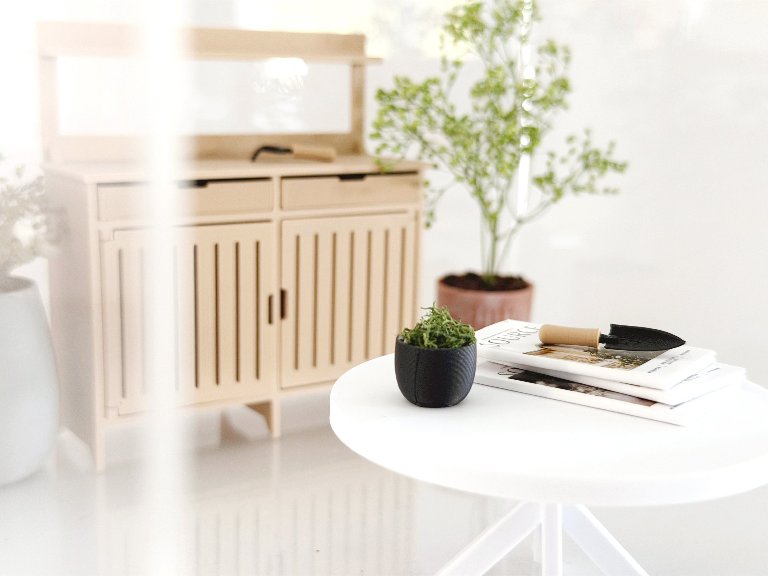 Garden-themed miniature magazines styled on a dollhouse coffee table or shelf.
