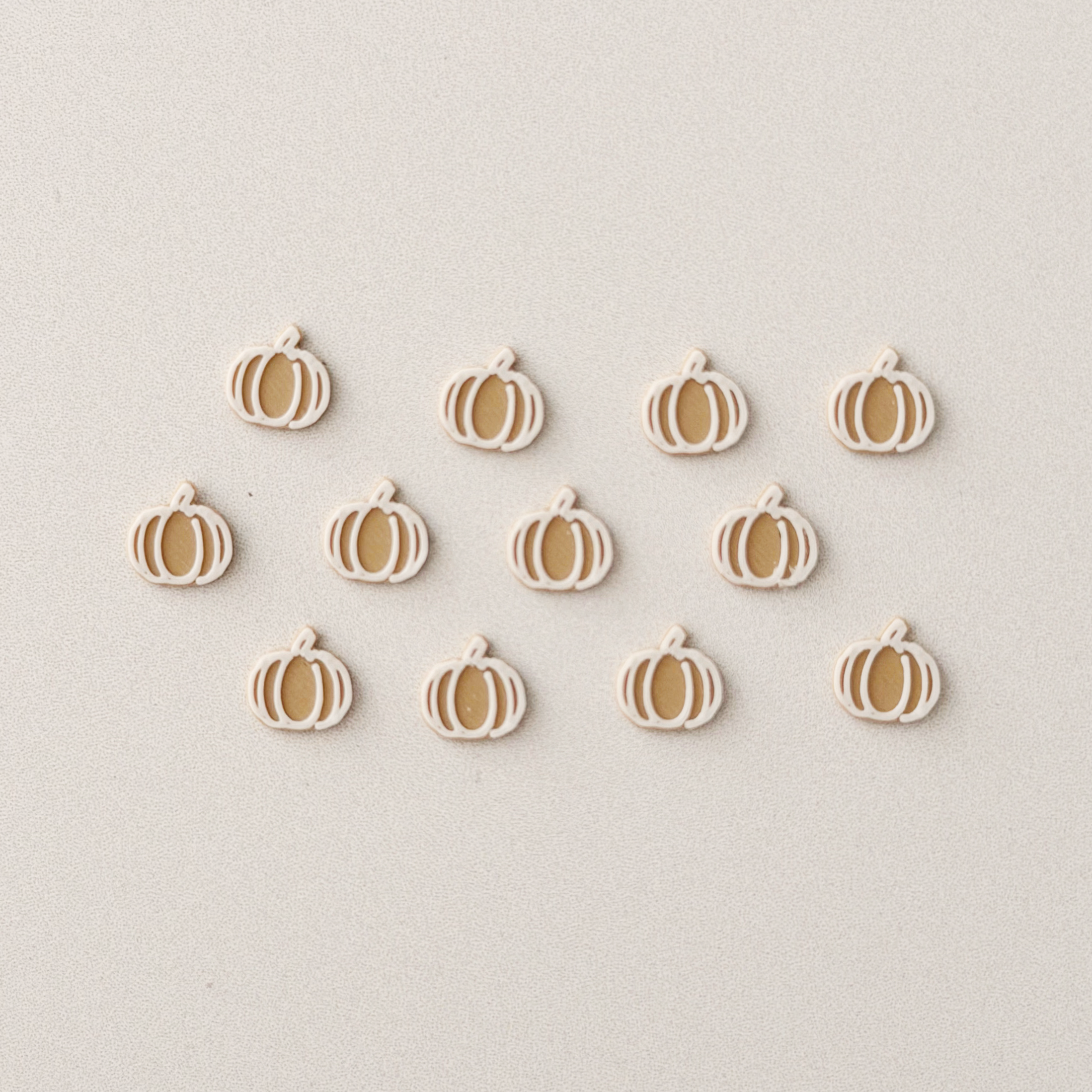 One dozen tiny pumpkin-shaped cookies for a 1:12 scale dollhouse