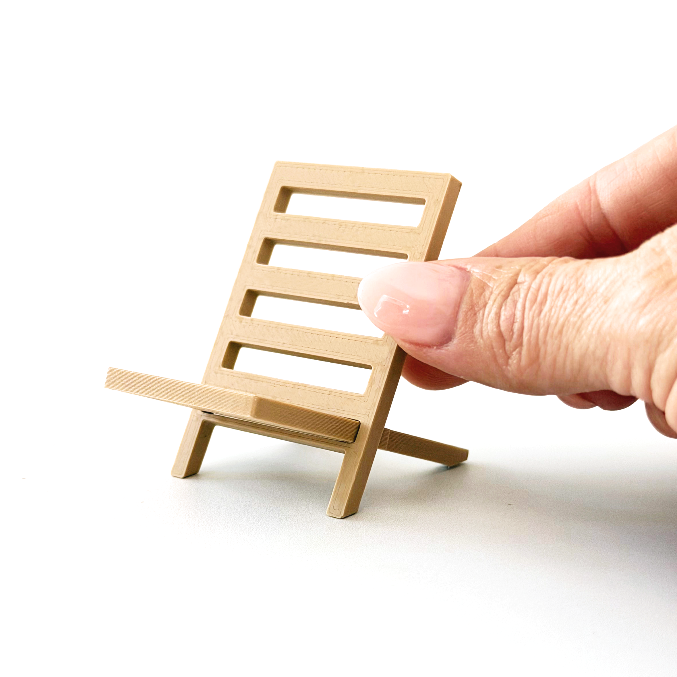 Mini camping chair shown next to fingertips for 1:12 scale size reference.