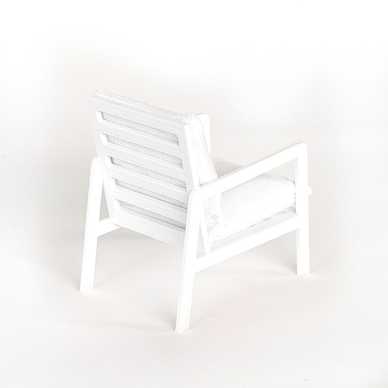 Close-up detail of miniature armchair showing smooth finish and structured design, 1:12 scale dollhouse furniture