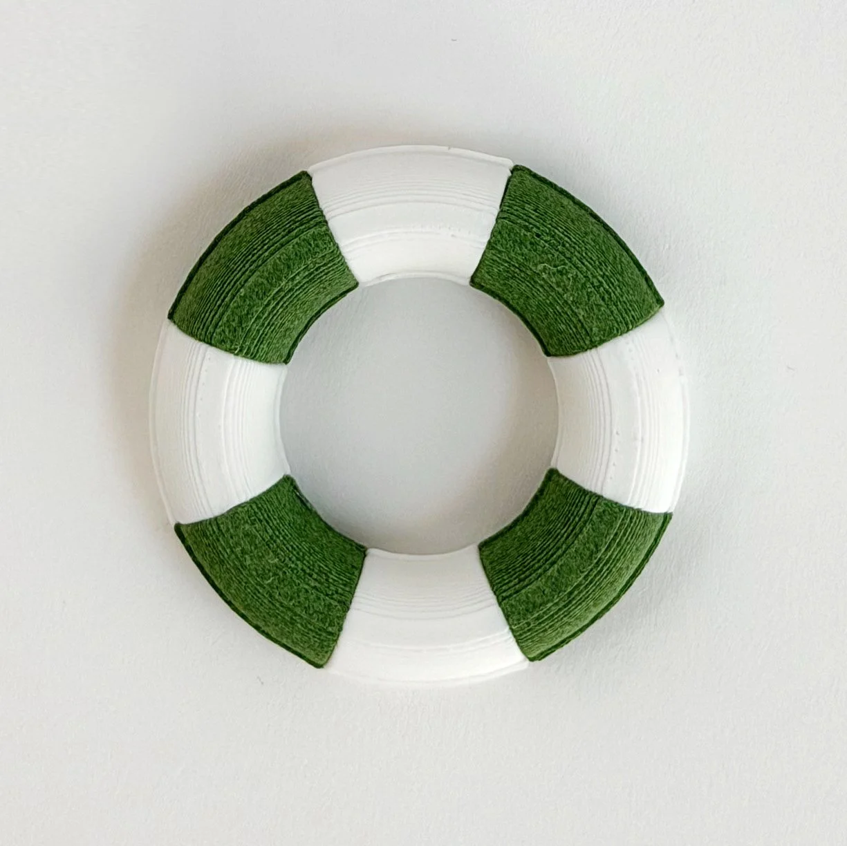 1:12 scale miniature pool float in Kelly green and white stripe styled for dollhouse summer scene