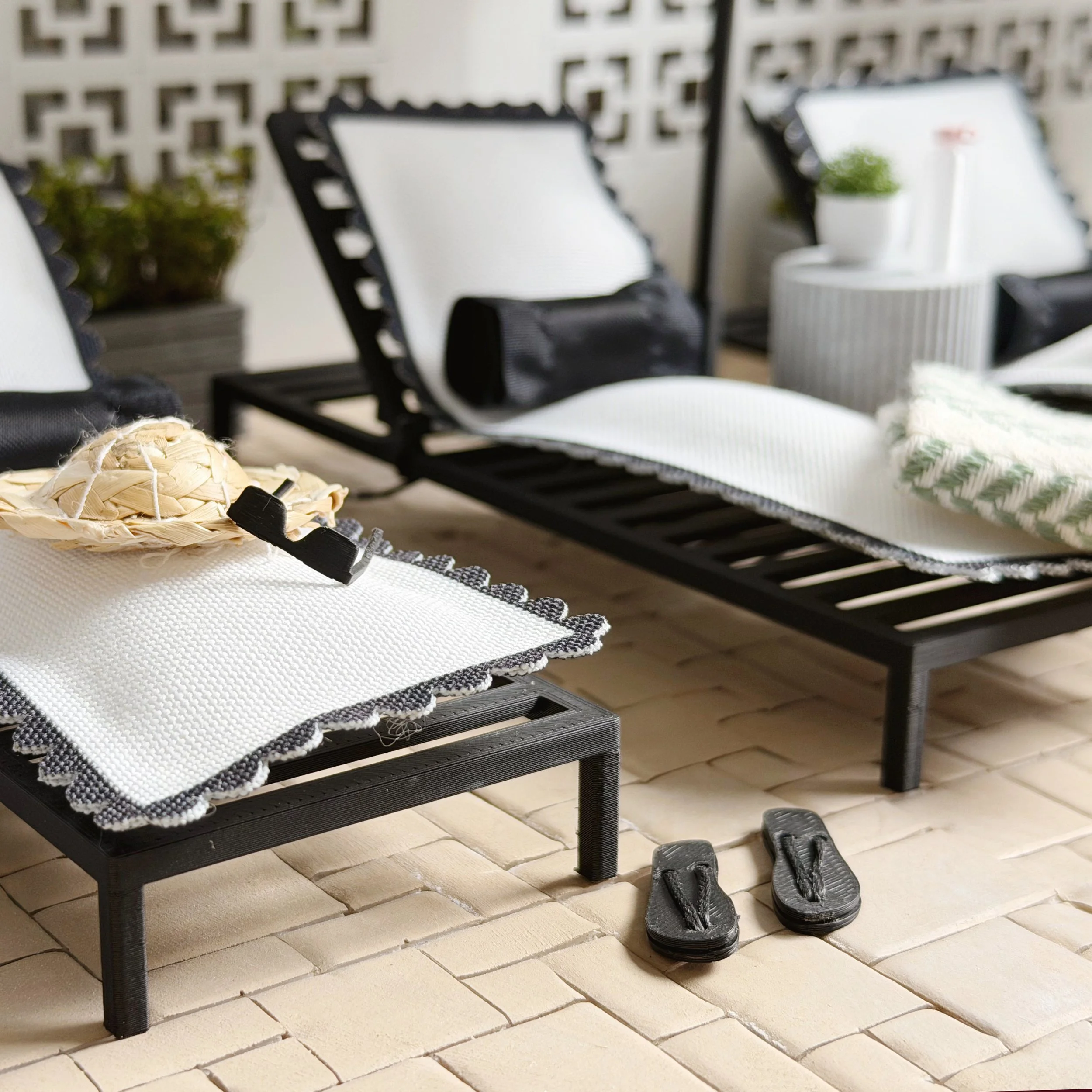 Miniature flip flops styled in dollhouse pool and patio scene