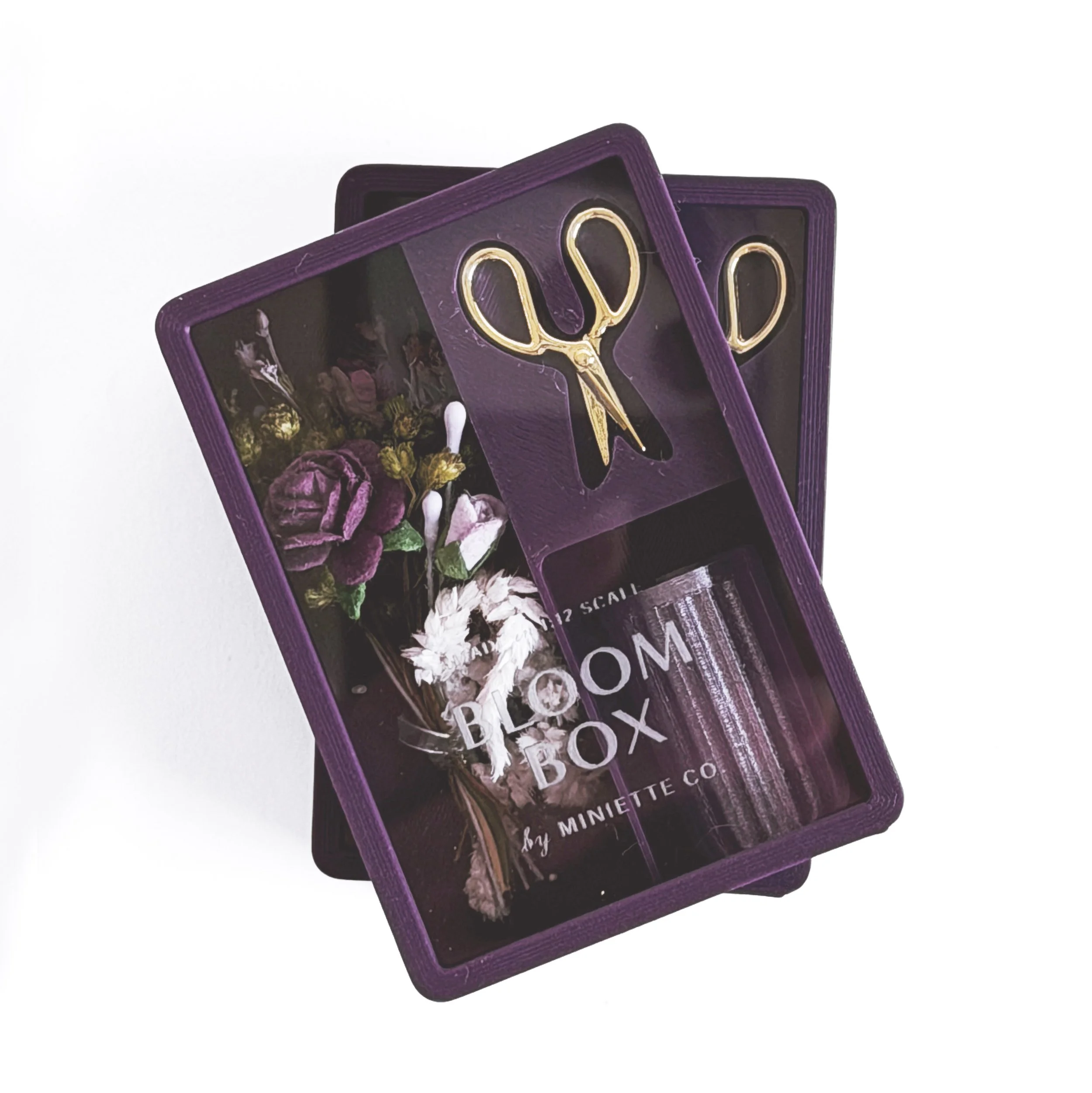 Set of purple Bloom Box miniature floral gift sets displayed together in clear packaging
