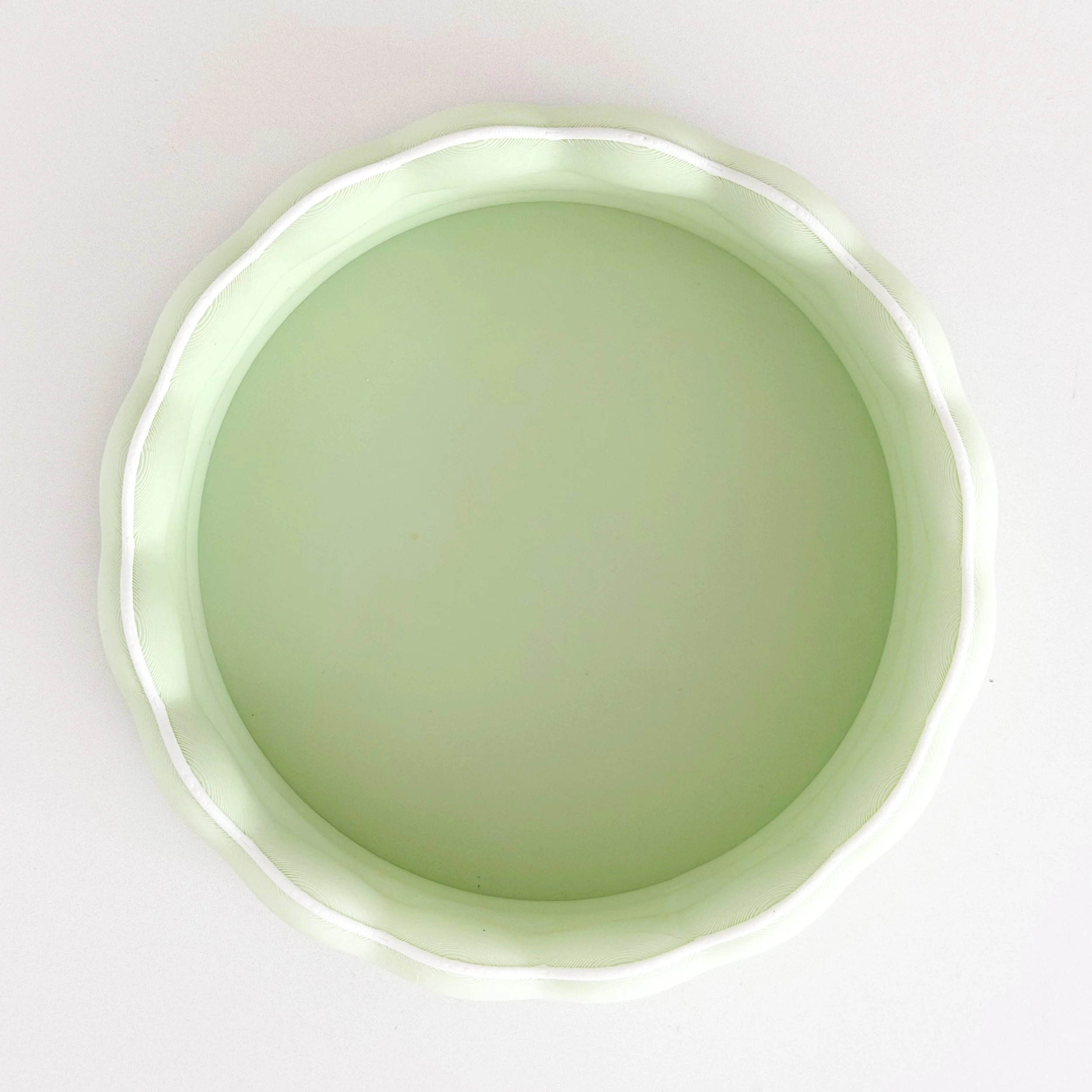 Top-down view of a modern dollhouse kiddie pool showing the scalloped shape.