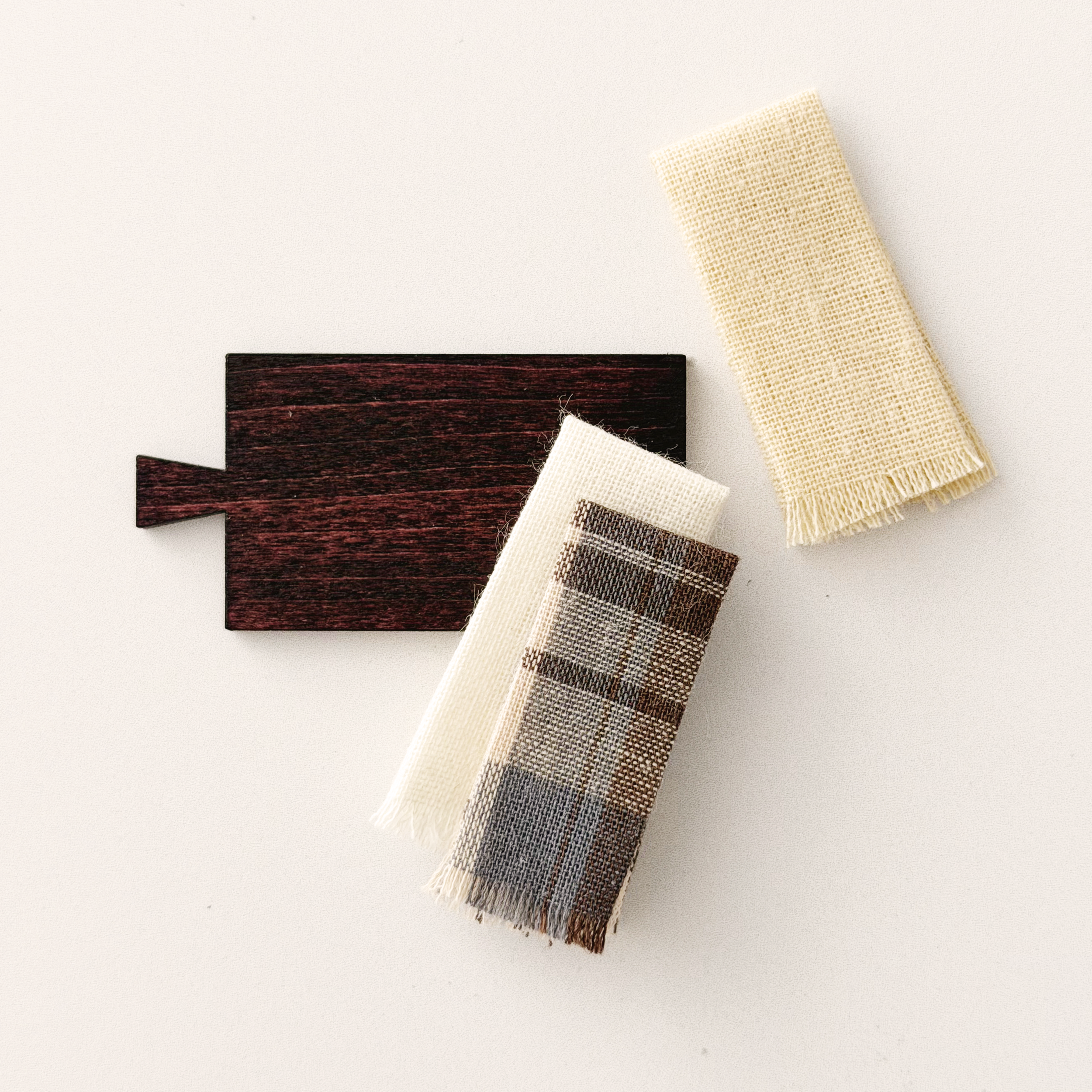 Miniature cutting board and folded towels styled for a cozy 1:12 scale kitchen