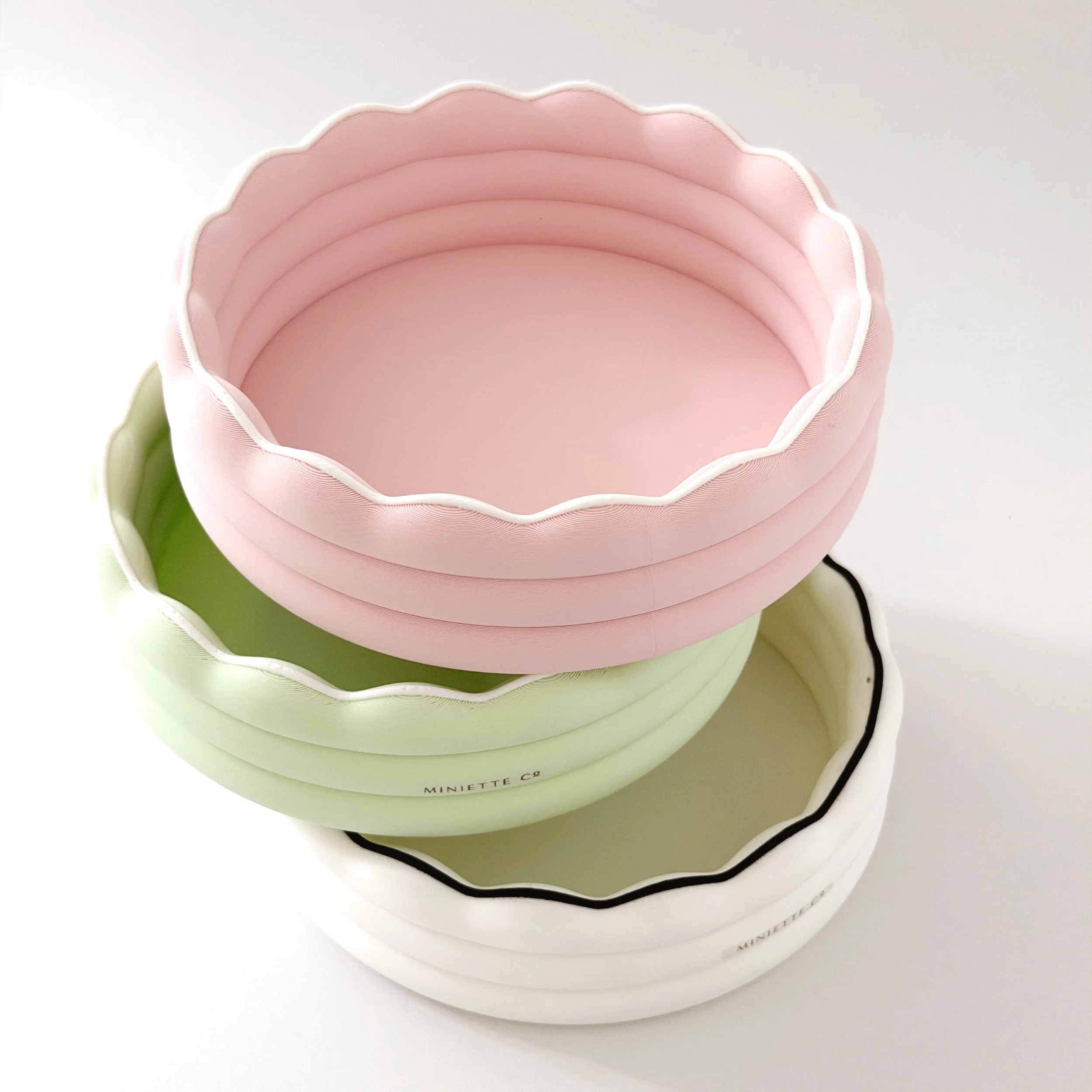 Miniature kiddie pools available in pink, green, and black color options.