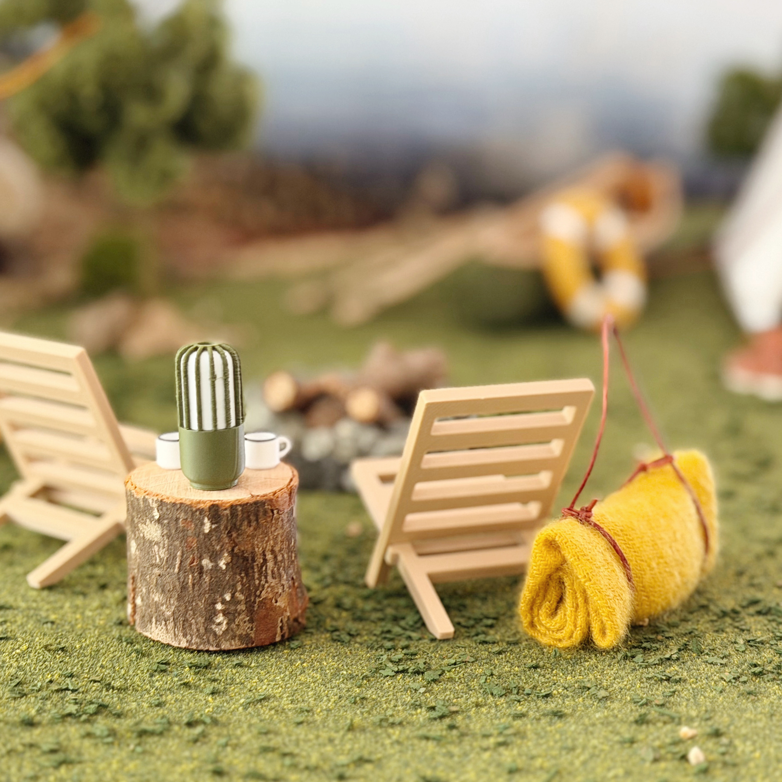 Dollhouse camping chair styled beside a miniature campfire.