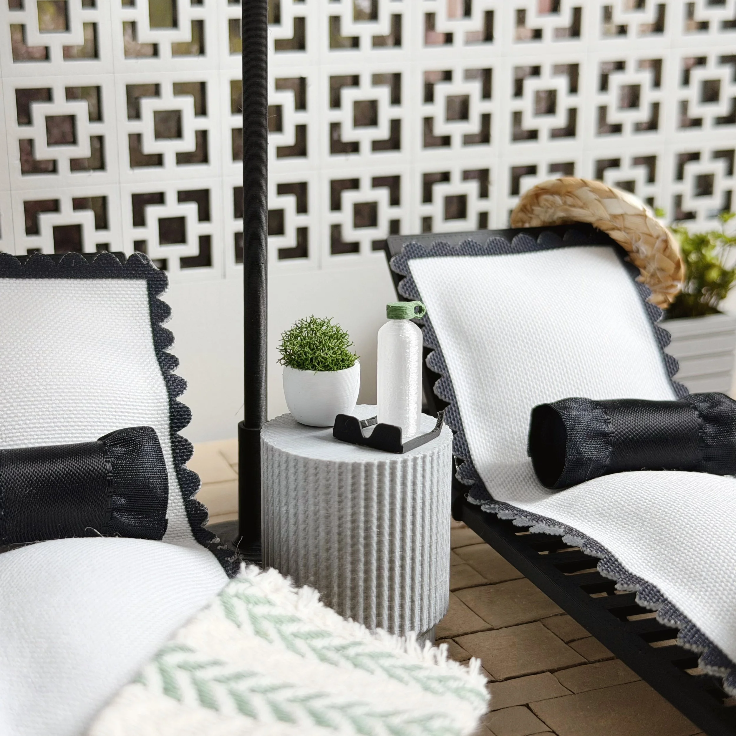 1:12 scale outdoor setup with water bottle placed beside loungers