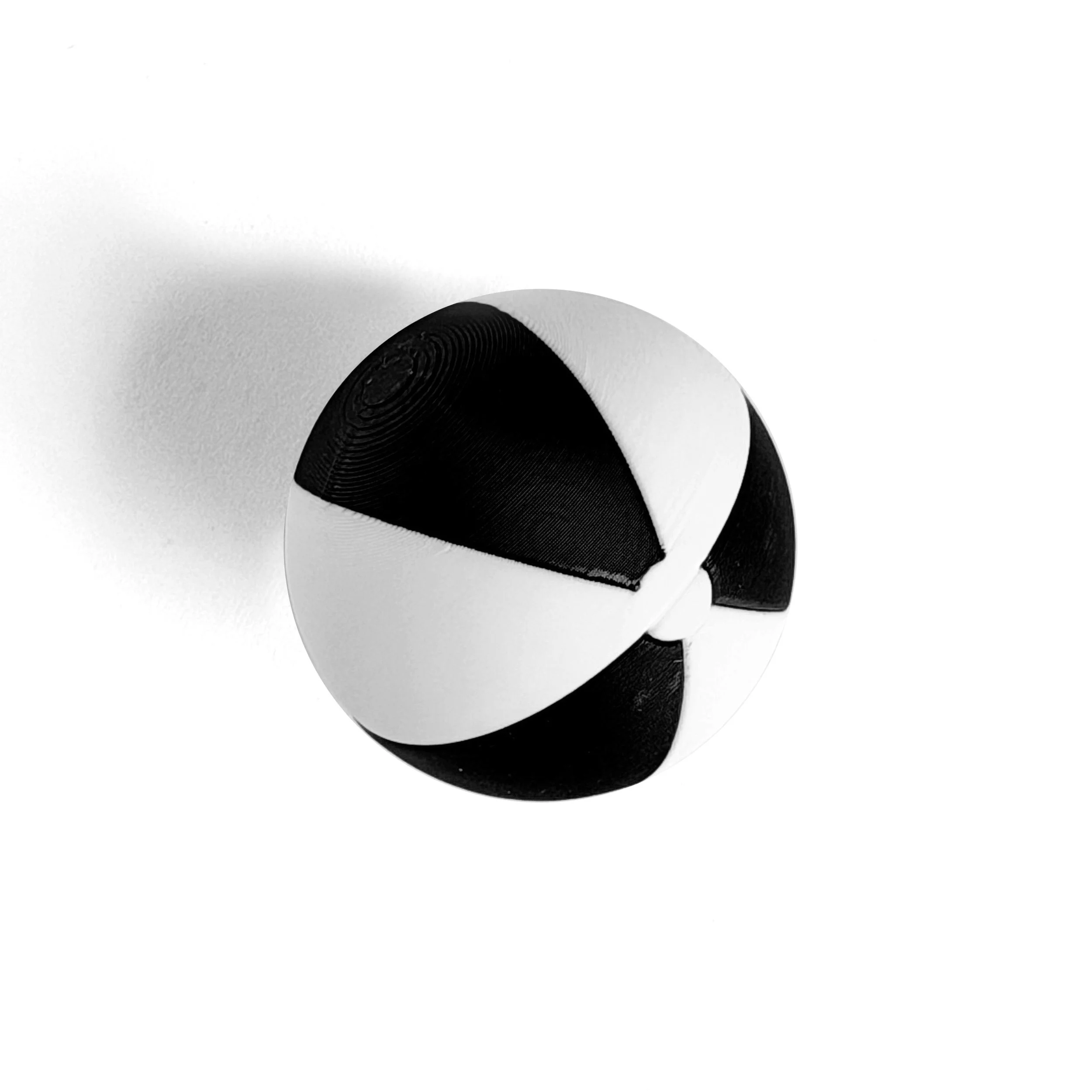 1:12 scale miniature black and white striped beach ball on white background