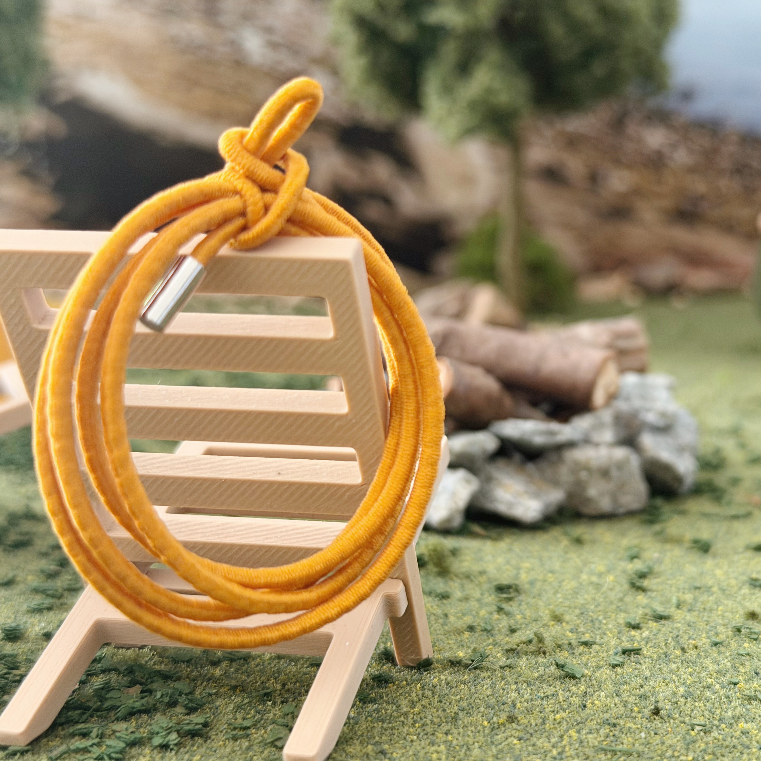 Miniature utility rope coiled for a 1:12 scale dollhouse camping scene.