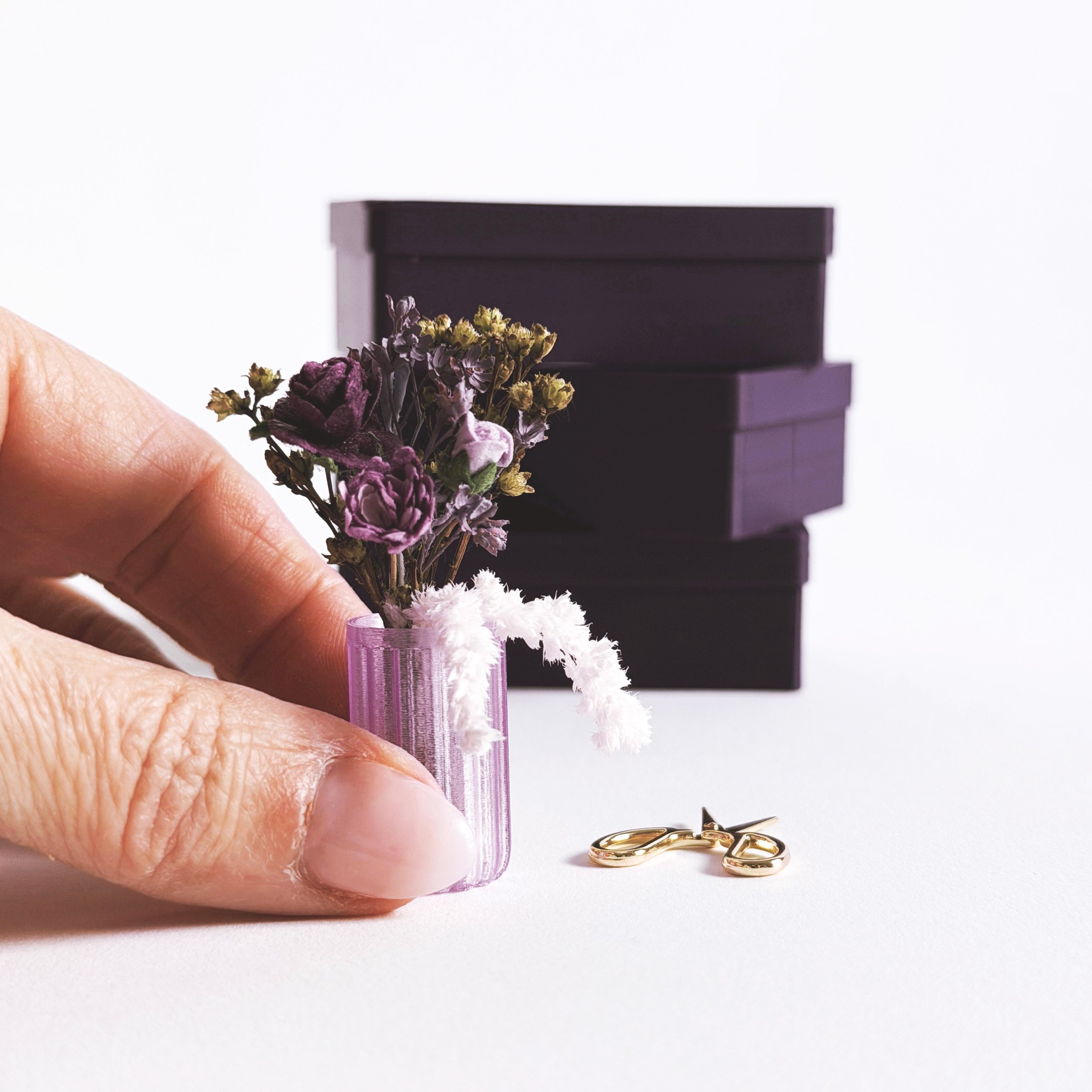 Miniature gold scissors and purple floral arrangement detail inside Bloom Box gift set