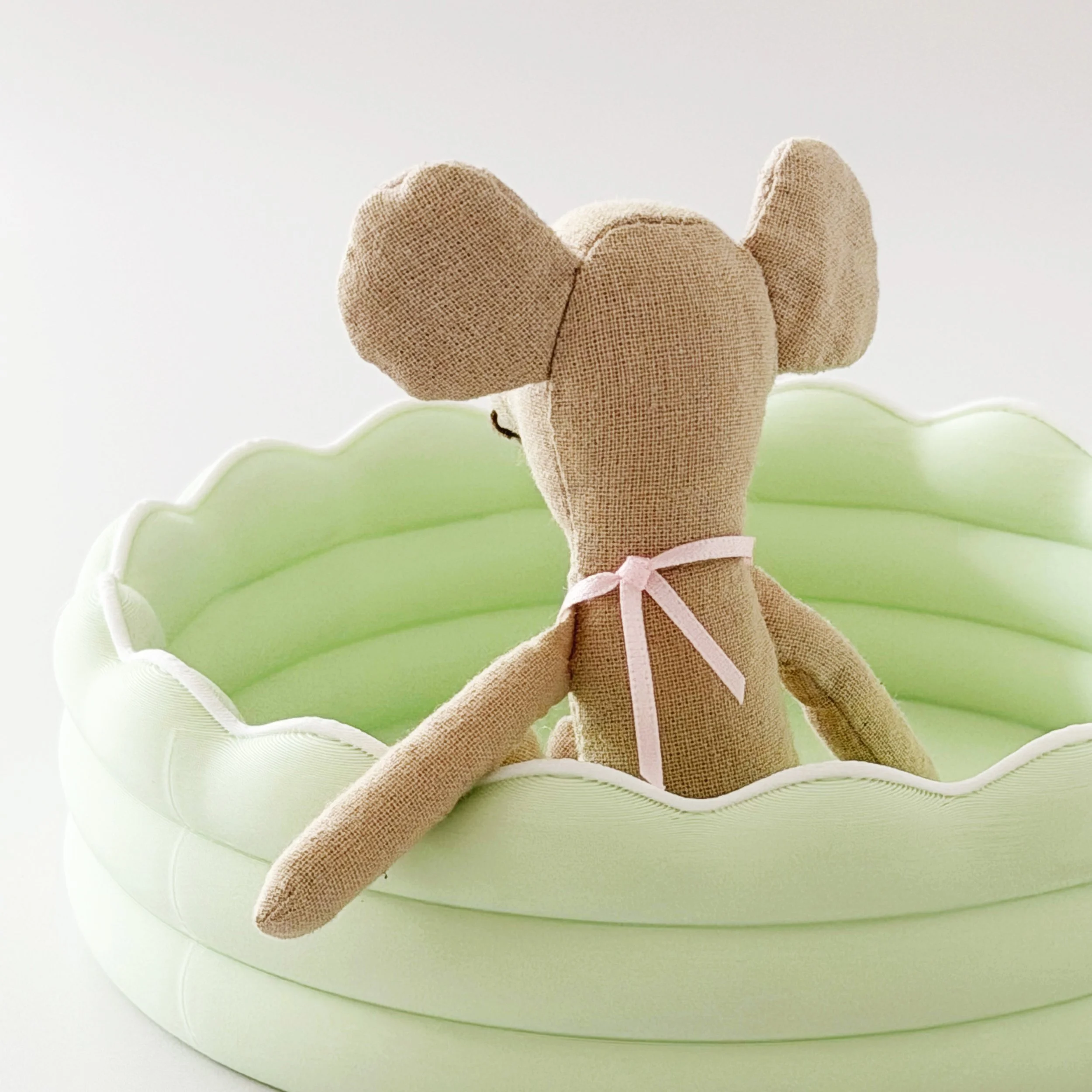 Close-up of the miniature kiddie pool showing its smooth finish and scalloped edge.