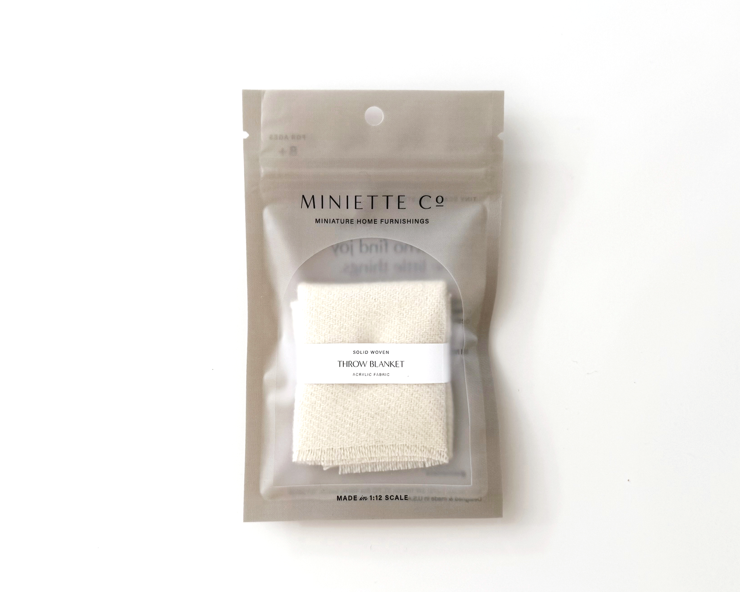 1:12 scale miniature dollhouse throw blanket in ivory, terra cotta, or royal currant. Handcrafted solid woven design with soft brushed fabric and fringed edge.