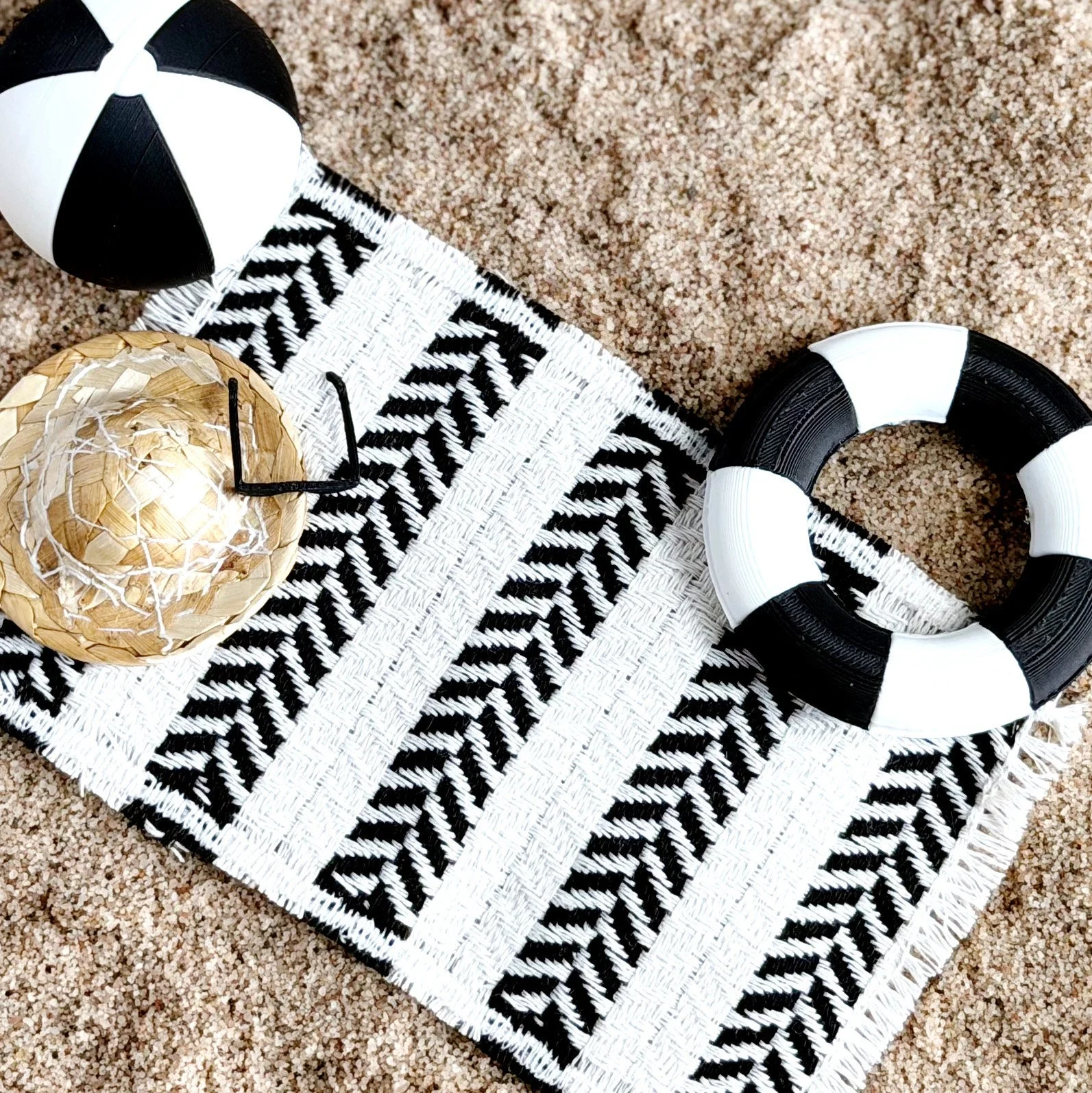 Miniature beach towel styled in a bright dollhouse summer scene