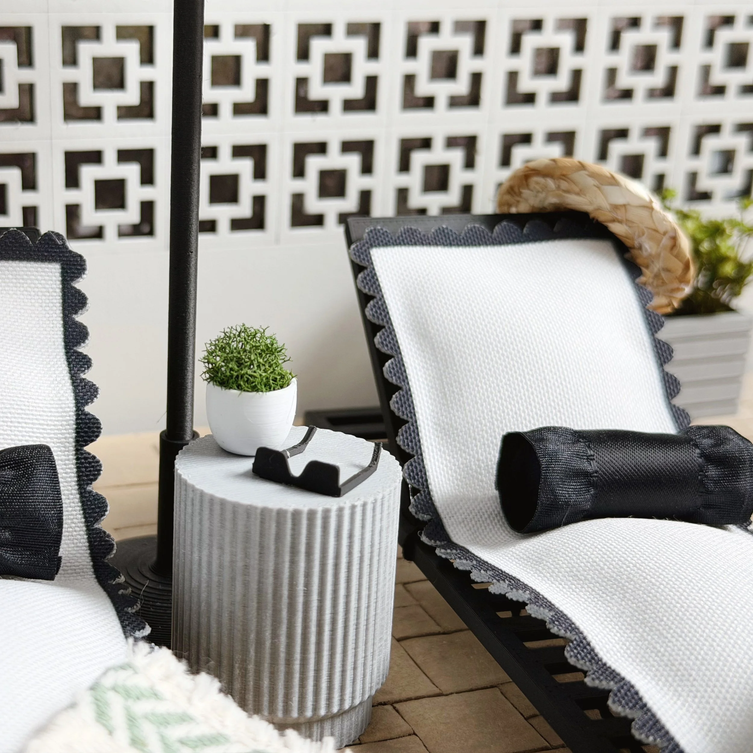 Miniature beach hat and sunglasses styled in a dollhouse poolside scene