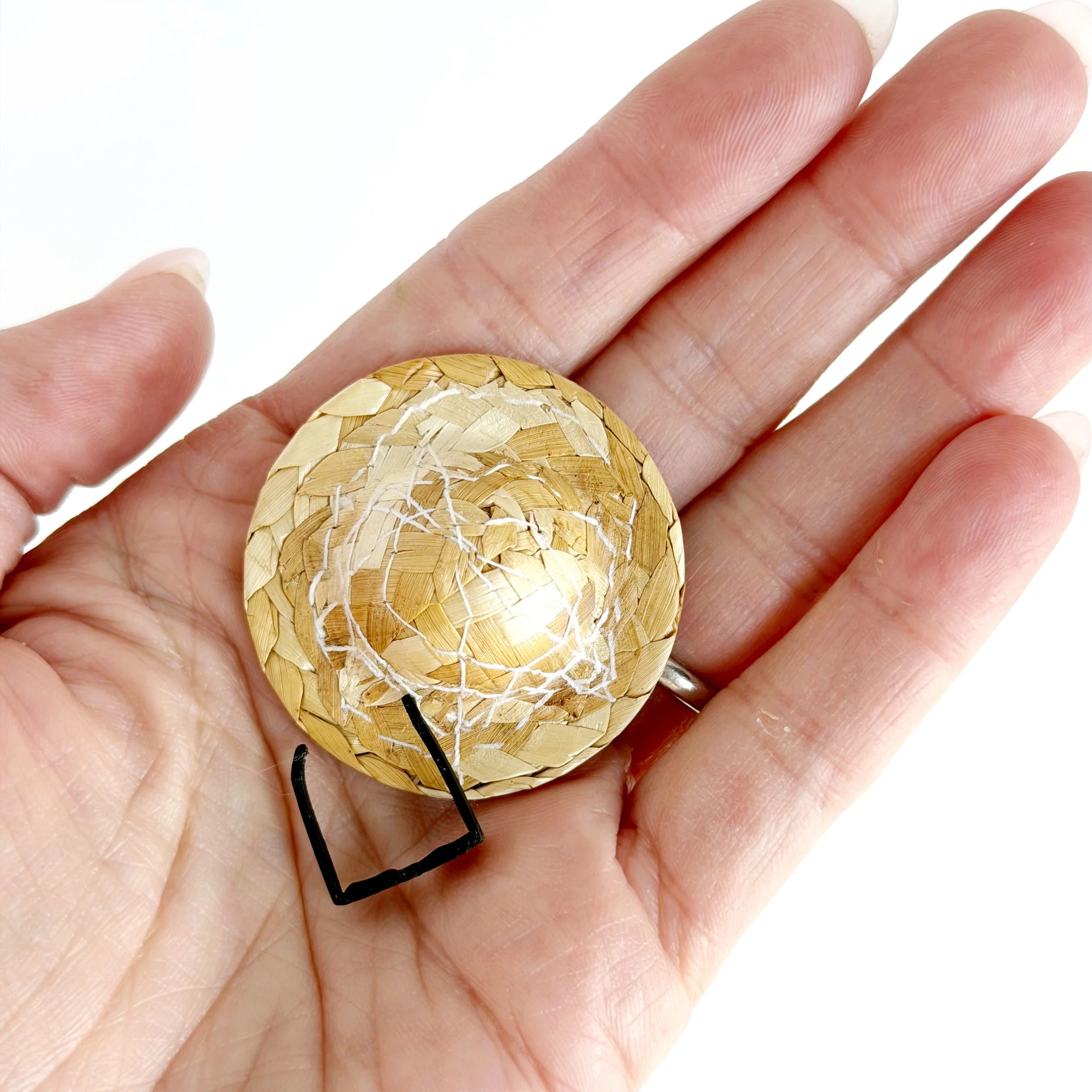 Hand holding miniature beach hat and sunglasses to show 1:12 scale size