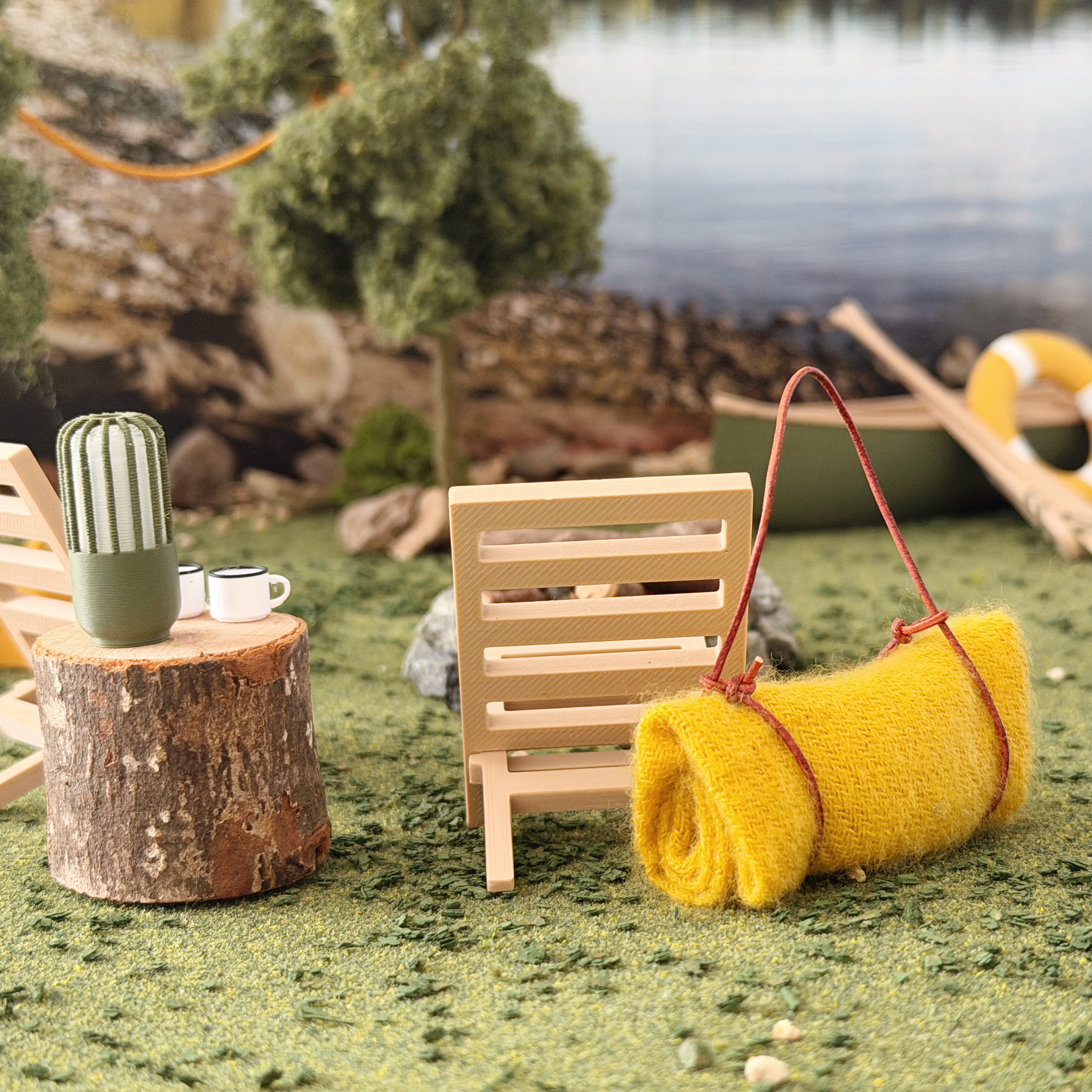 Rolled picnic blanket accessory for dollhouse camping and cabin scenes.